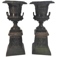 Pair of Cast Iron Urns on Plinths