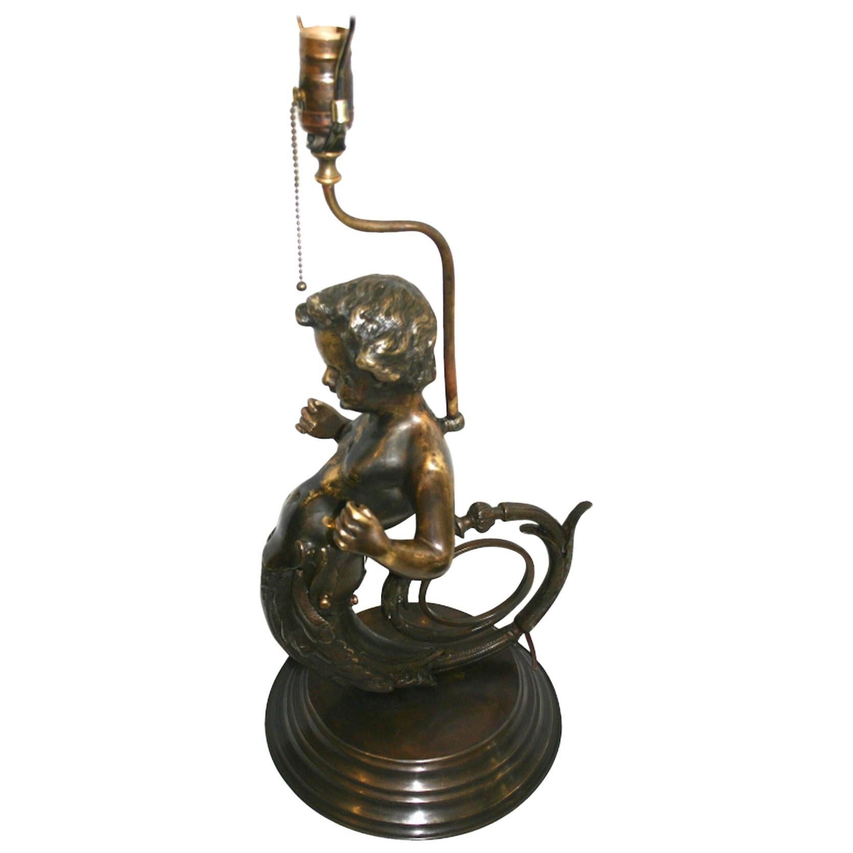 Pair of circa 1930's French patinated bronze lamps with shape of a putti.

Measurements:
Height of body 22