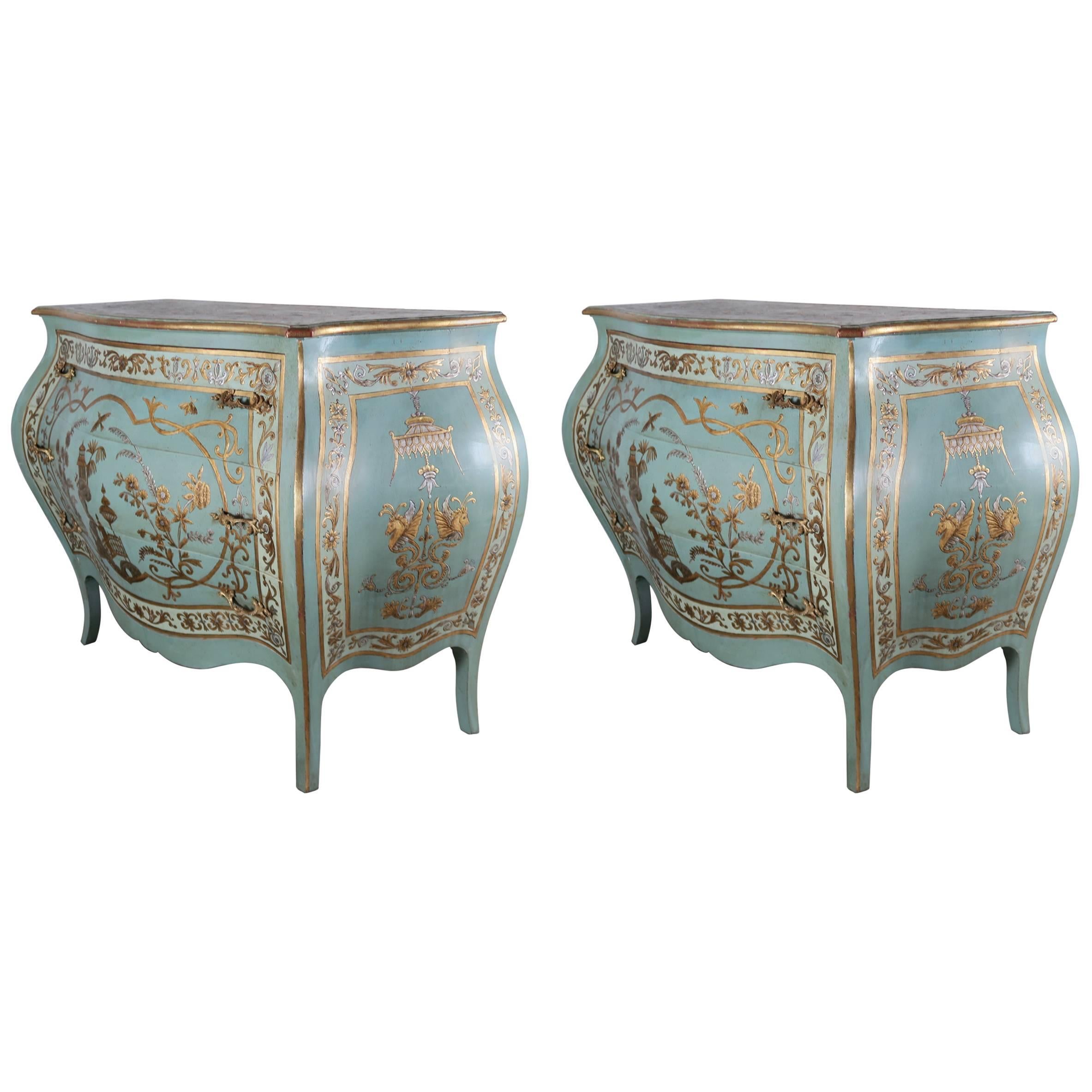 Pair of circa mid 20th century French blue painted serpentine shaped bombe commodes finely decorated in hand-painted raised gold and silver chinoiserie design. Original brass hardware.