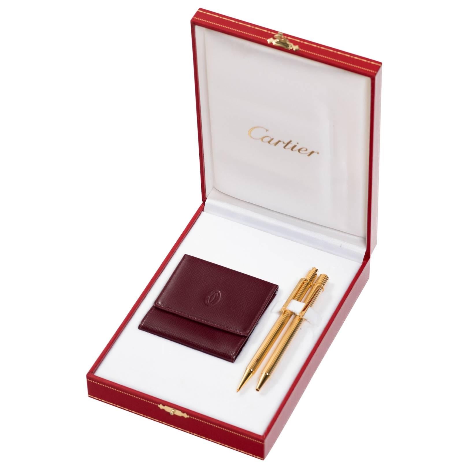 Parure de stylos et crayons Cartier avec porte-monnaie en cuir