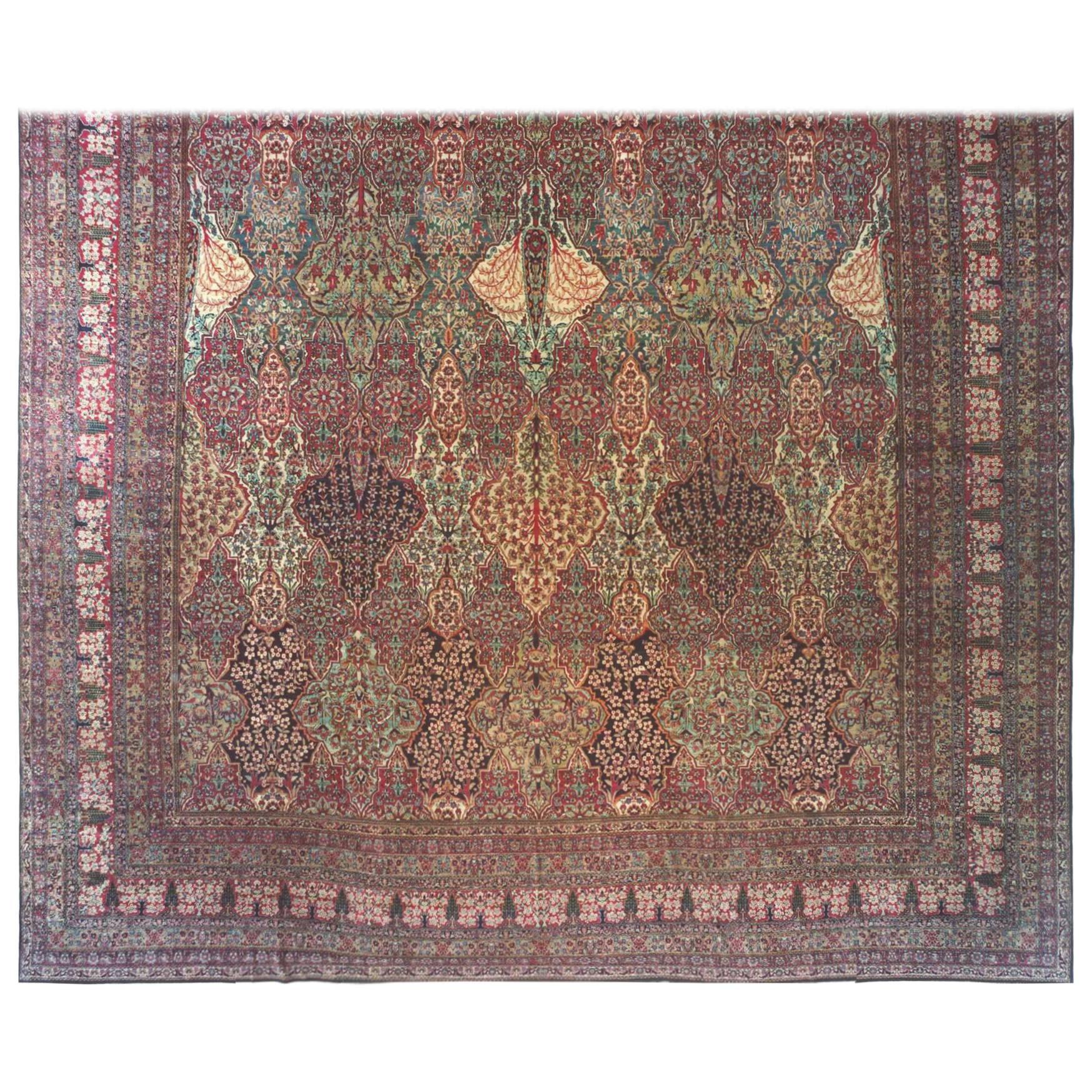 An antique Persian Lavar oriental carpet, size: 33'1 x 17'10, circa 1880. This handwoven oversized master work has an incredibly fine weave, and is characterized by a repeating diamond petagh design in the immense central field. The combination of