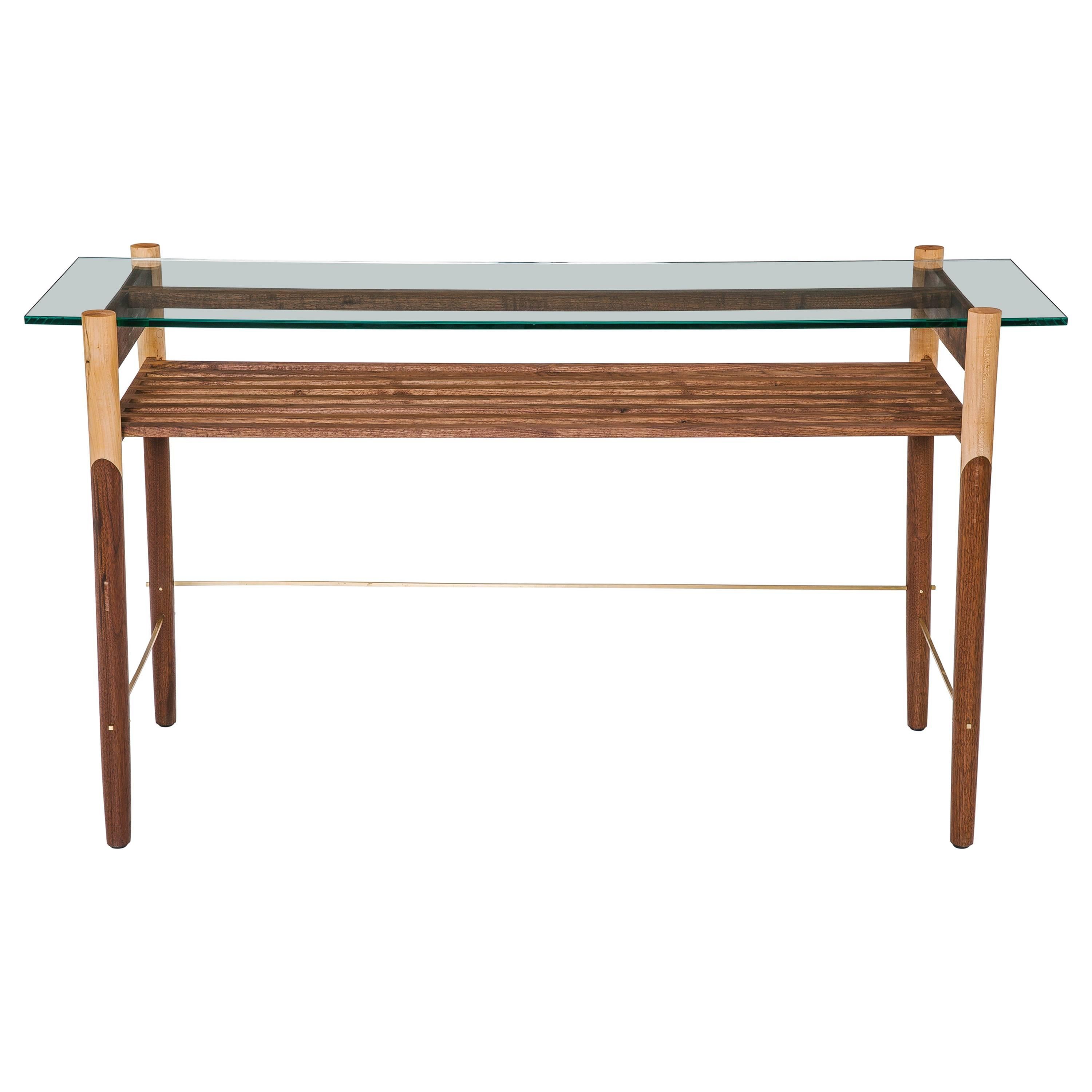 Hand-turned solid wood base. Polished tempered glass top. Fine metal accents. Handmade in Los Angeles, California.

Shown in walnut, maple and brass with clear tempered glass.   

Wood type is available in ebonized oak, white oak, solid walnut,