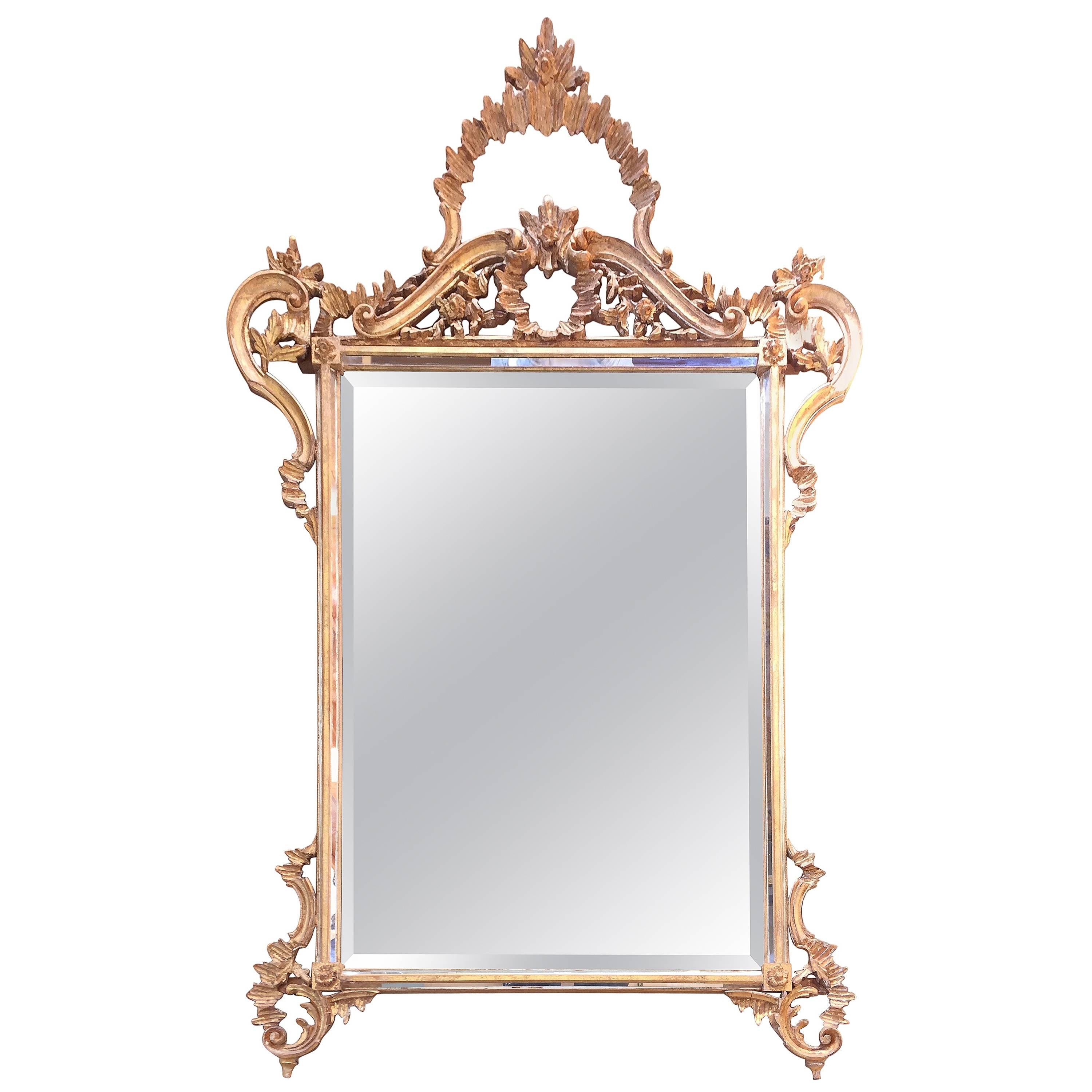 Lovely large fancy giltwood mirror having bevelled mirror and inset mirror detailing around the inside edges with elegant Italian giltwood frame.
33.25 W at bottom.