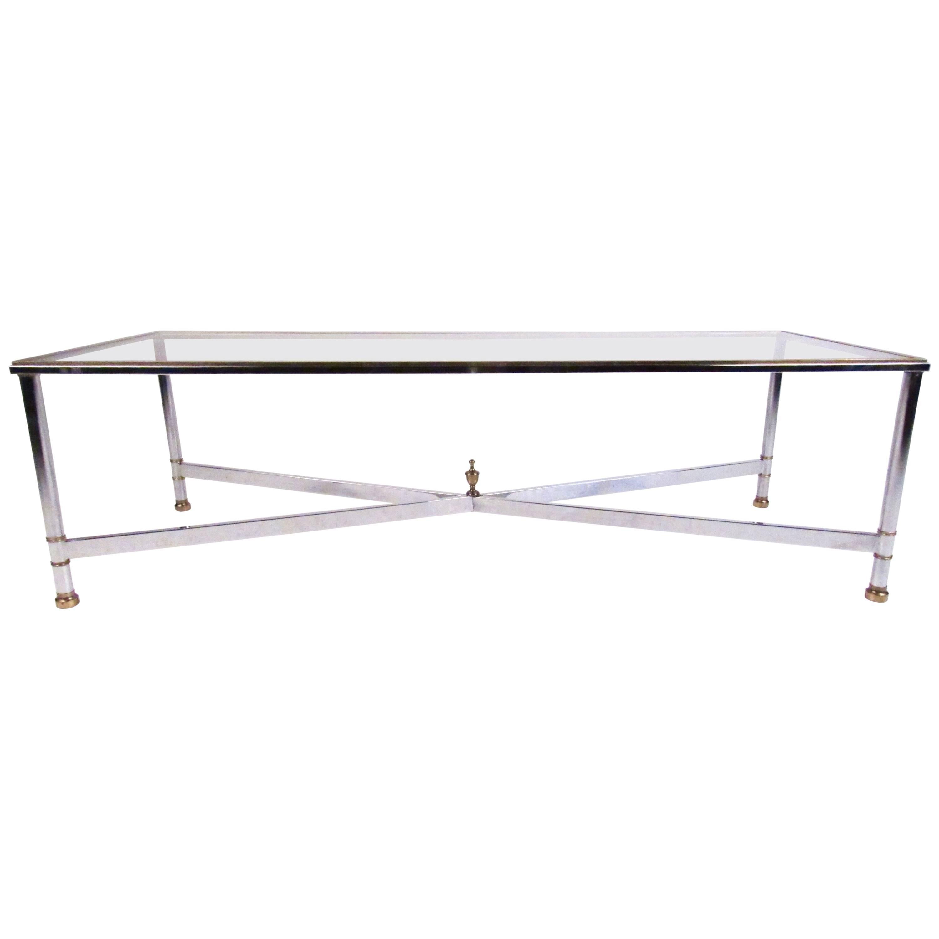 This vintage rectangular coffee table features sturdy chrome construction with beautiful brass trim. X-style stretcher adds stability and Mid-Century style to the piece while the unique size of the table makes it an impressive addition to any