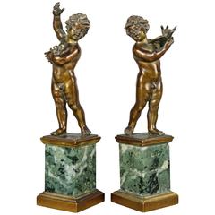 Pair of Italian Bronze Putti on Marble Plinths