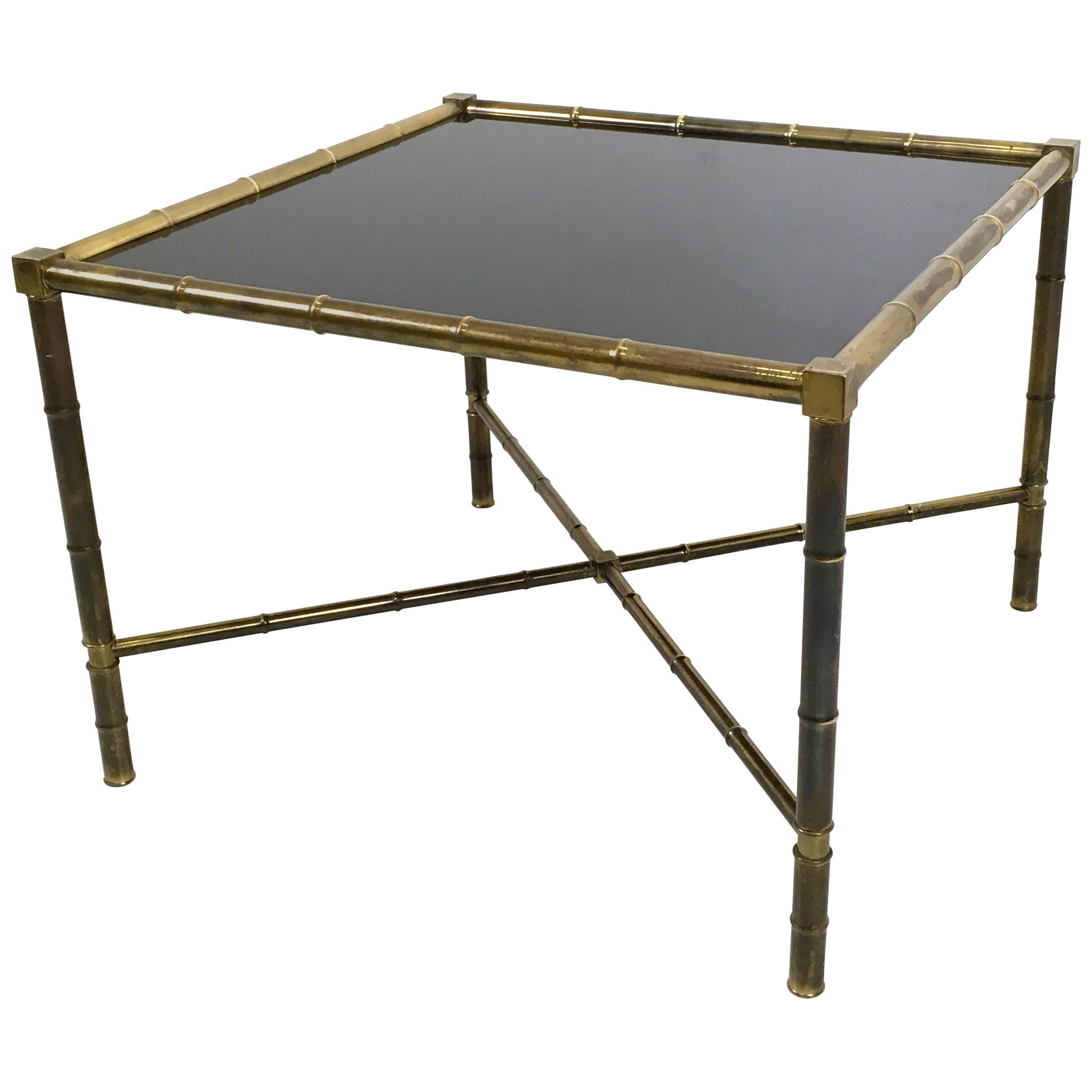 Made in France. 
It features a brass frame and a black opaline glass top.
This coffee table has its original patina, but on request we can clean the brass. 
It is a vintage item, therefore it might show slight traces of use, but it can be