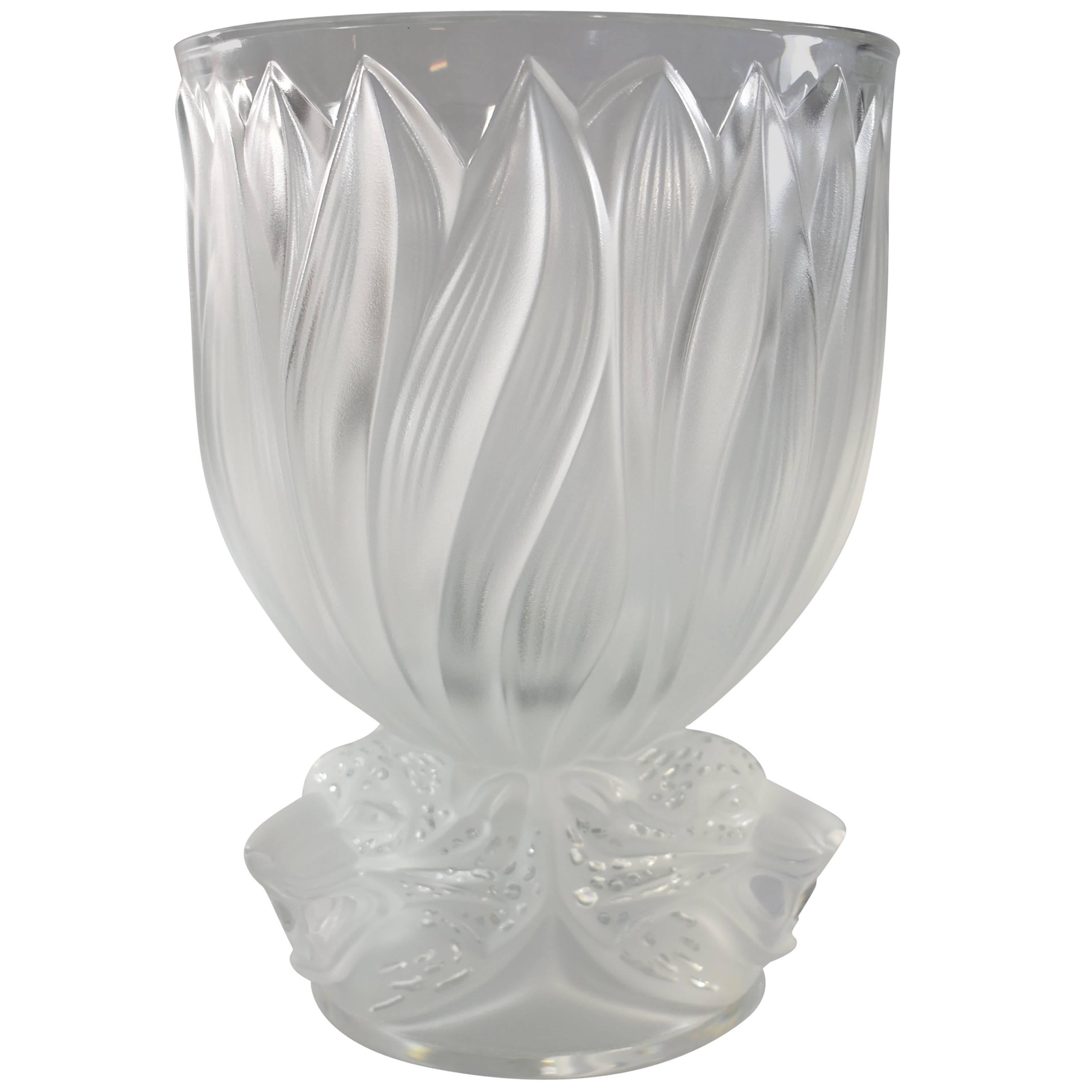A large gorgeous vase by Lalique France with its origianl box. It is best described as " three jaguar heads which seem to leap out of the tropical jungle like totems, decorate the base of this vase in clear satin-finished crystal, while the