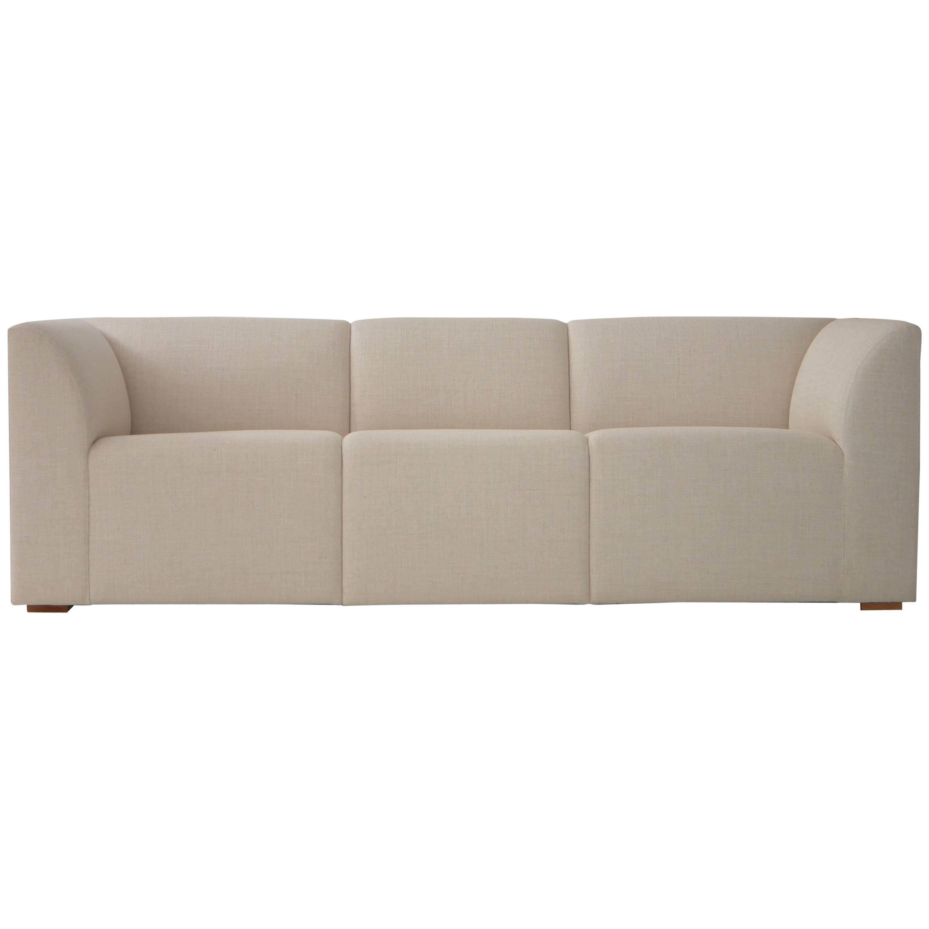 Michael Hurst, French designer now residing in Mexico City designed this prototype sofa in 2002. The piece was acquired directly from the designer in 2014. The sofa has just been reupholstered in a natural linen. Swatches available. About 5 or 6
