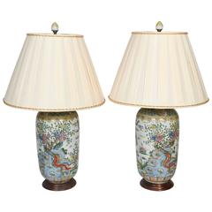 A pair of Chinese porcelain Famille Verte urns fitted as lamps