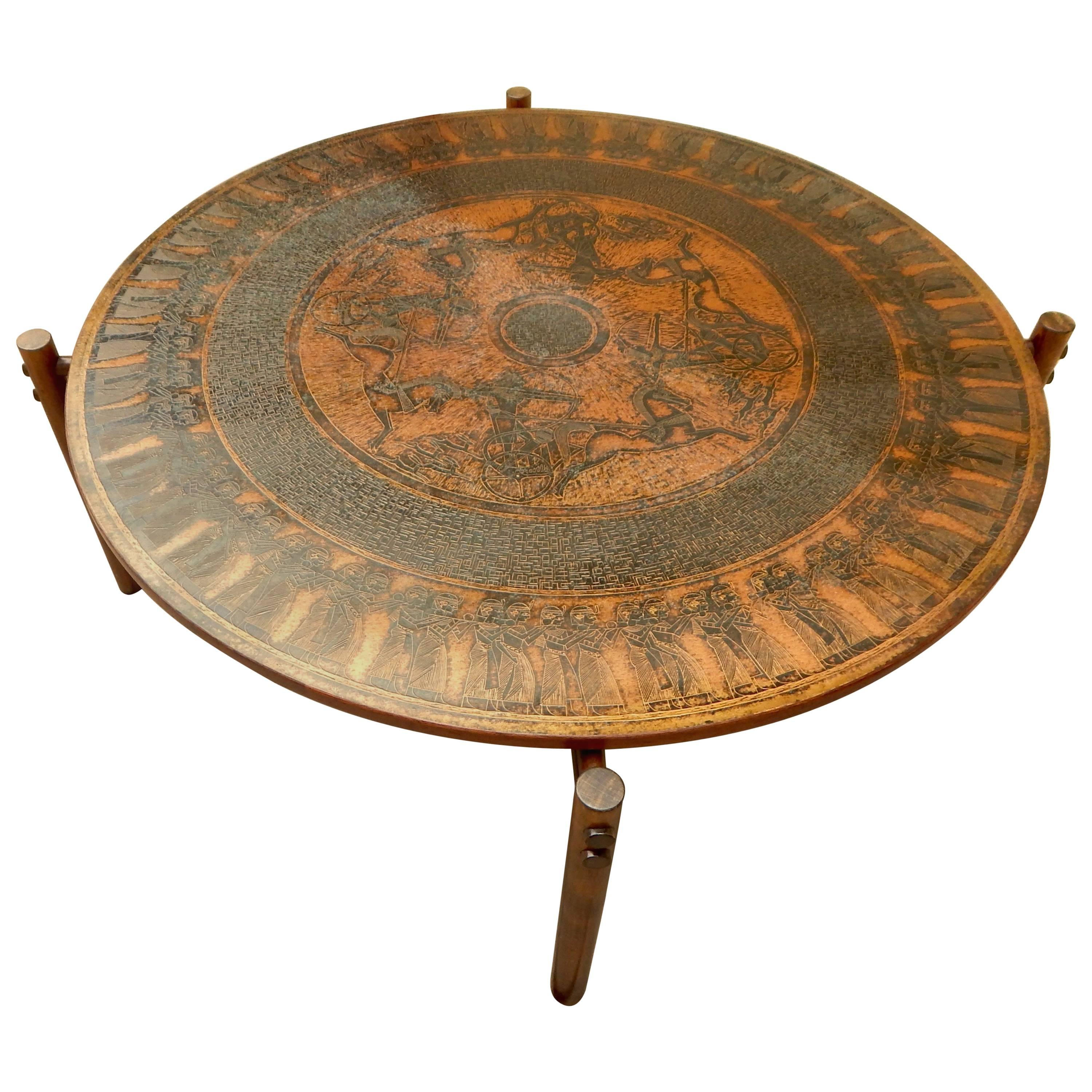 Norwegian coffee table with stamped copper top in neo-Egyptian themes. Crafted by Vad Trevare fabric Norge, circa 1970. Base in solid, stained birch wood. Exposed wood joinery.