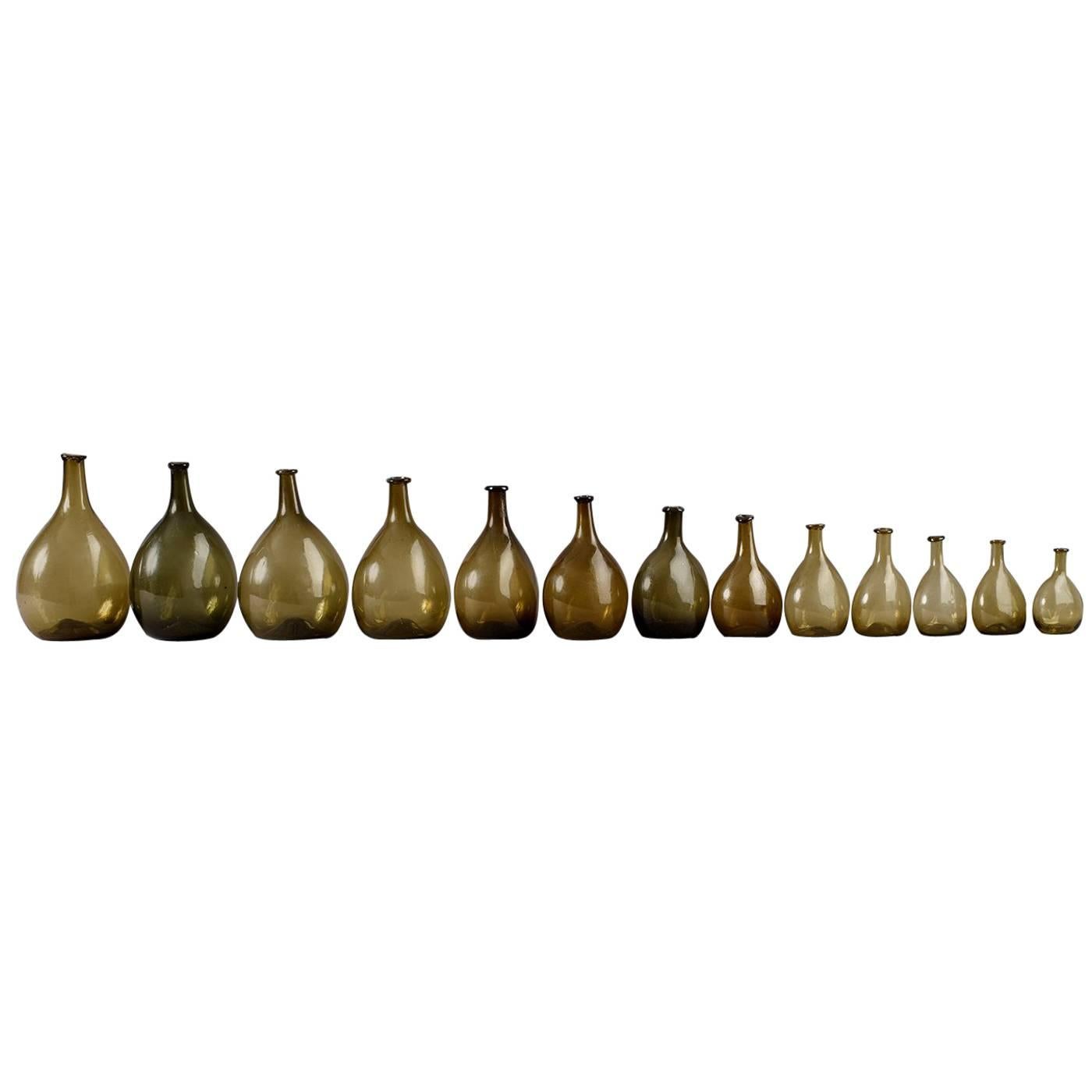 Set of 13 Free-Blown Glass Chestnut Bottles For Sale