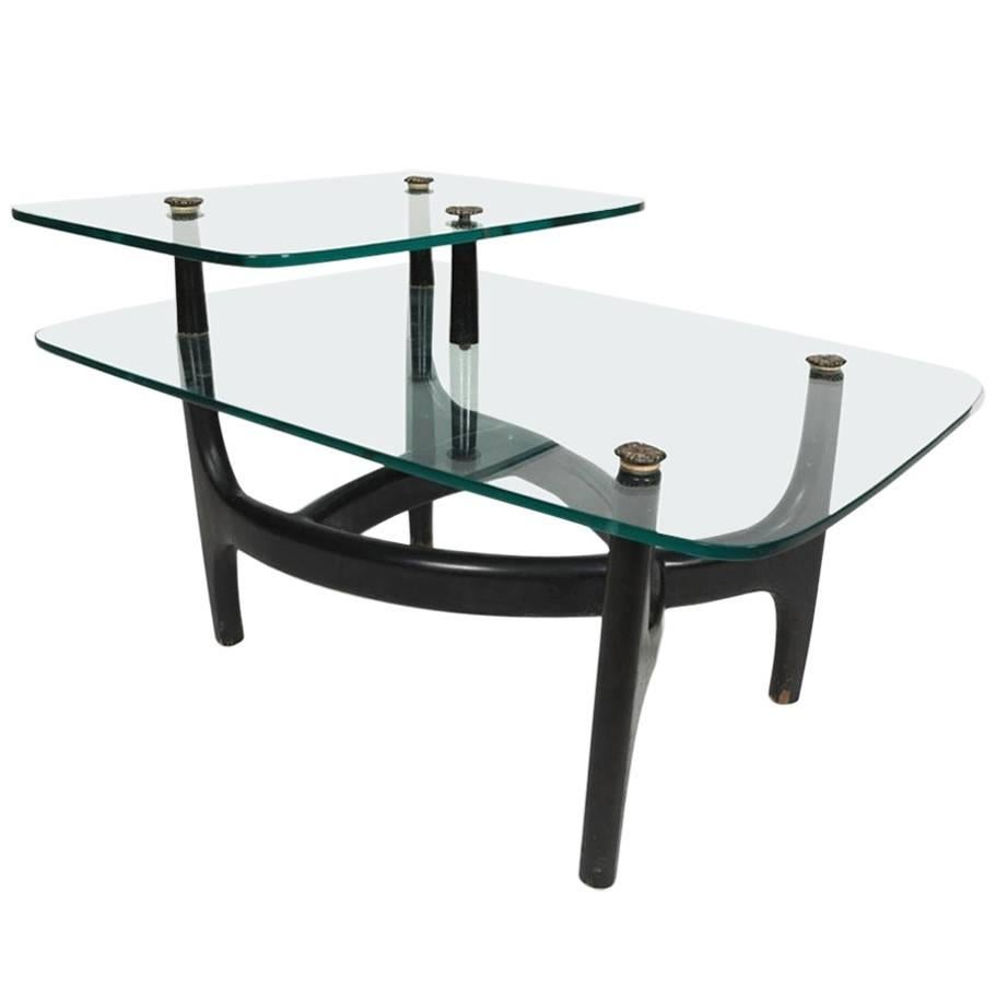 This elegant hand made pair of two-tier glass top end tables has an ebonized hardwood biomorphic frame. 