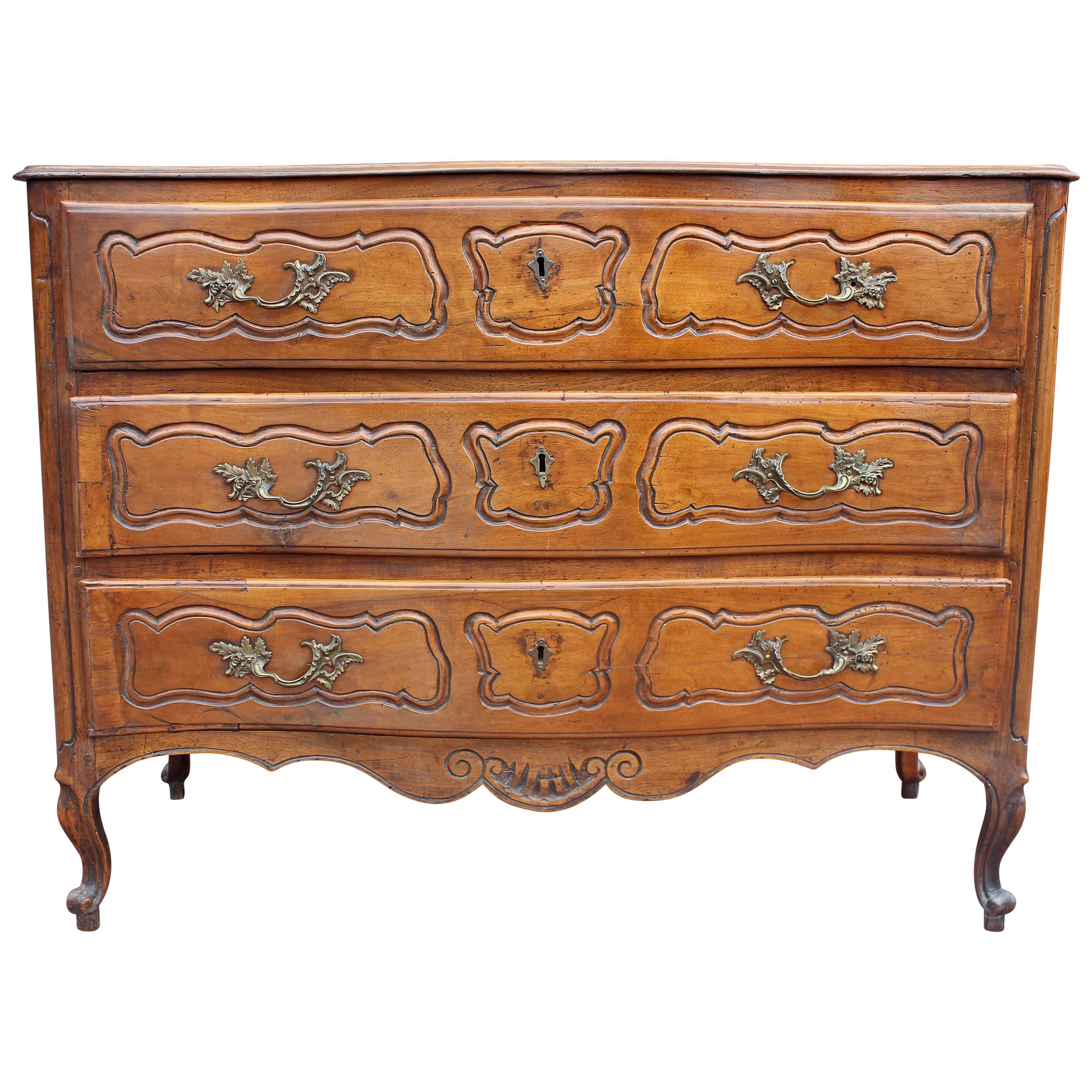 French Louis XV  Provincial 18th century serpentine commode chest of drawers. Carved drawer fronts and side panels. Carved cabriole legs. Original hardware. Warm color and good size. Fruitwood.