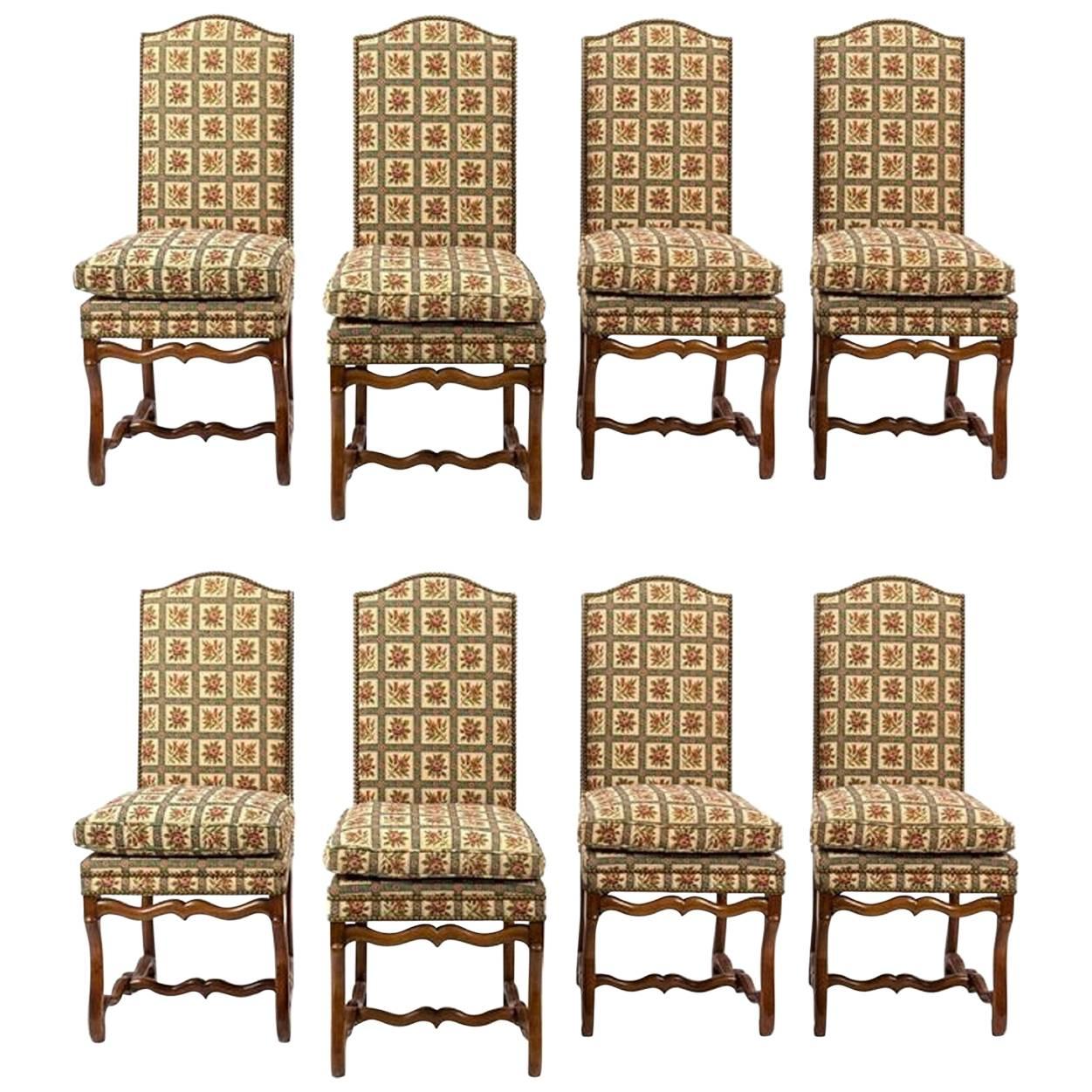 Set of eight Italian walnut and upholstered dining chairs, 20th century. Having upholstered backs and seats, with H-form stretchers.
       