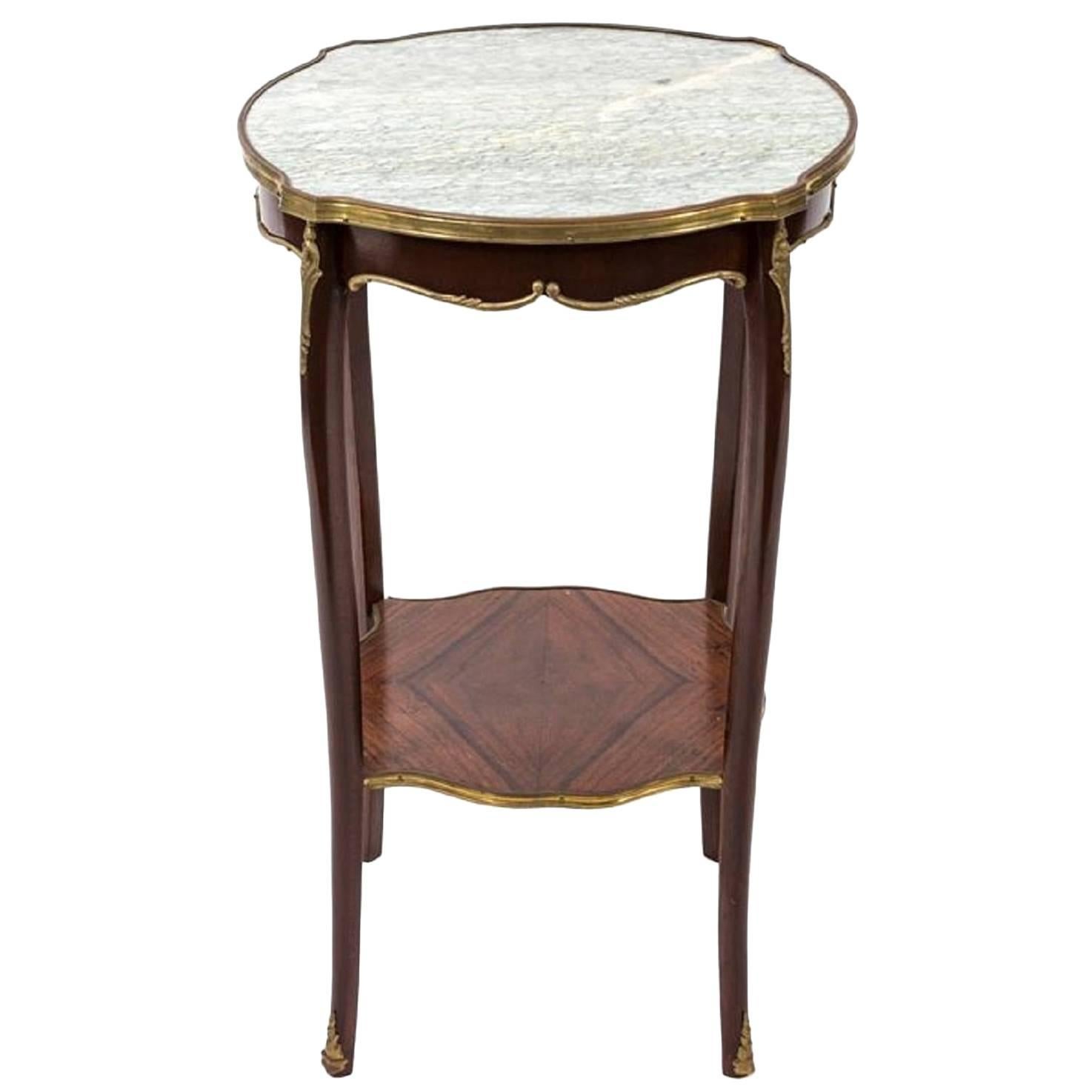 Louis XV style gilt and marble-top gueridon or side table, Early 20th century.  Bronze accents and stretcher shelf.
 