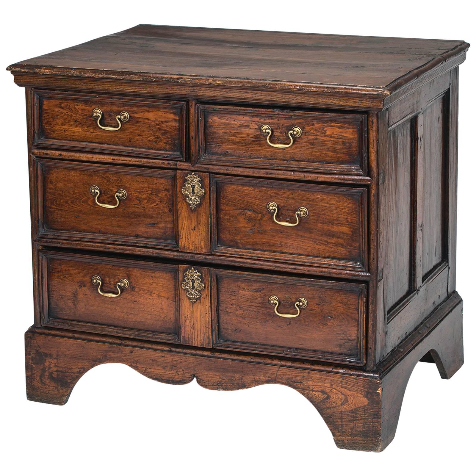 English commode with four drawers, circa 1880s. Warm English oak, panel sides, dressed with brass hardware handles. A simple practical serving chest.  Great for sink commode cabinet.