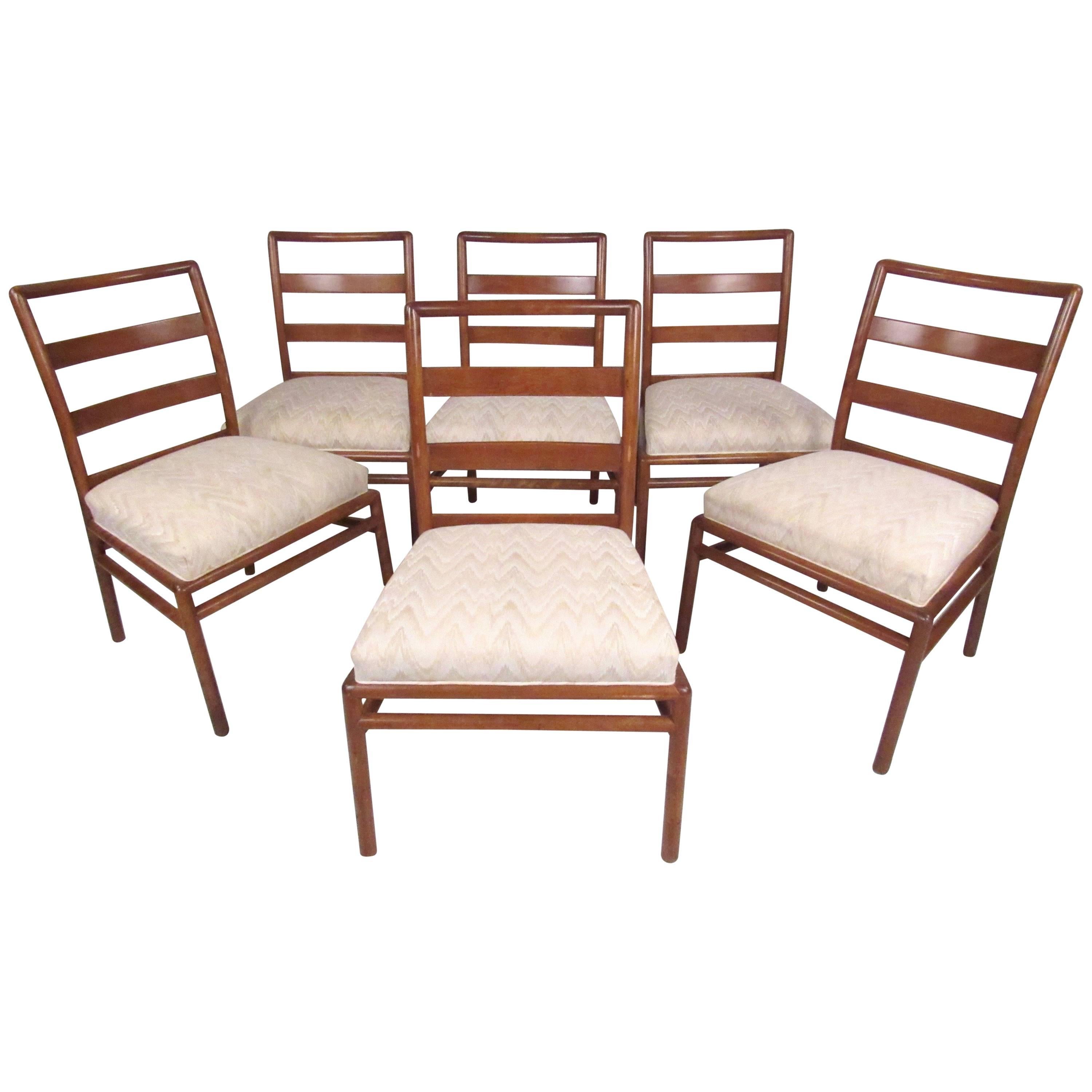 This stylish dining set by Robsjohn-Gibbings includes his iconic x-style base and six matched dining chairs, all featuring unique and sturdy Mid-Century construction. The stylish seat backs and upholstered seats add to both the style and comfort of