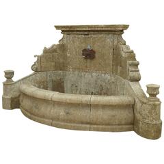 Unique Wall-Fountain Carved in French Limestone with Curved Basin and Sculptures