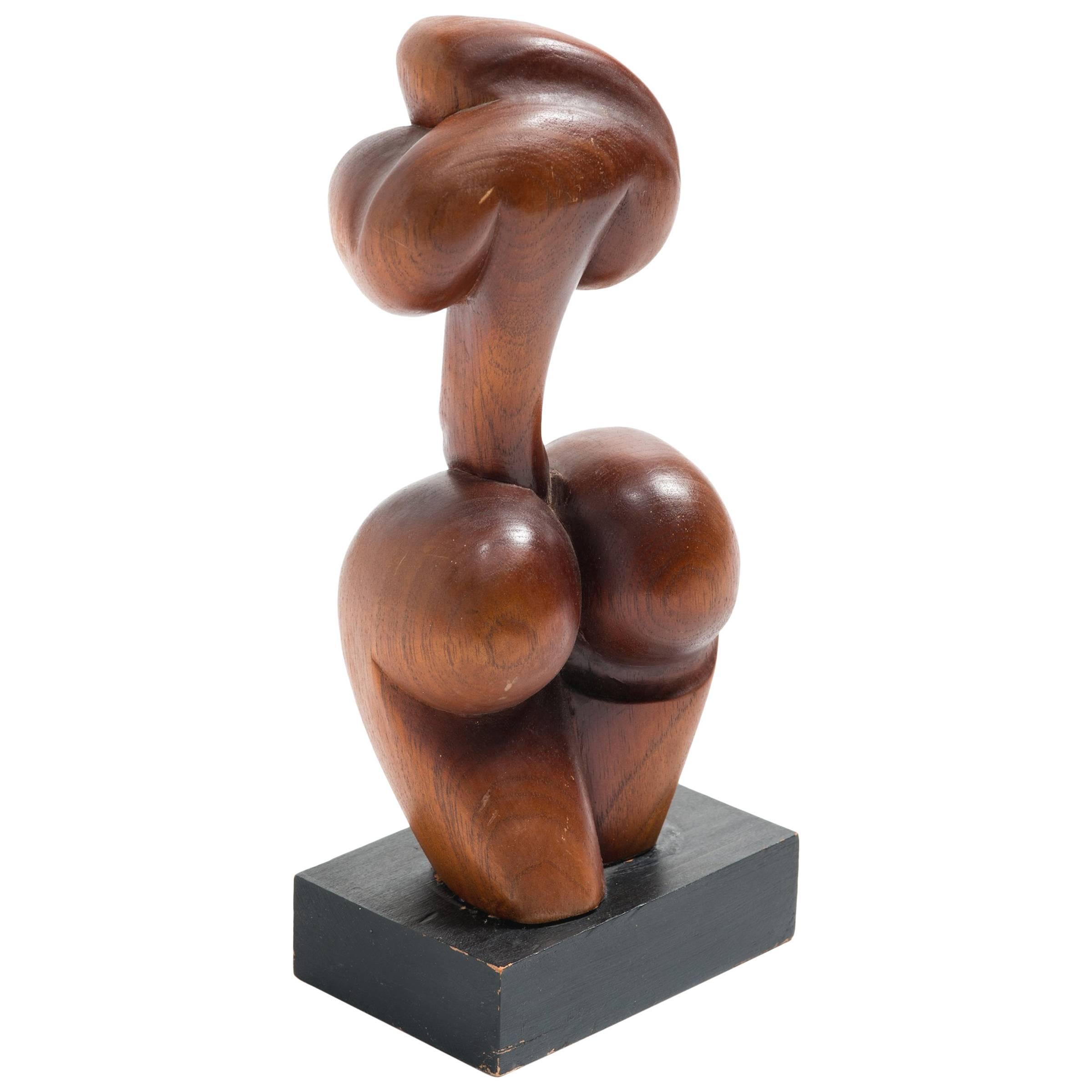 Hand-carved wood abstract sculpture of a female.