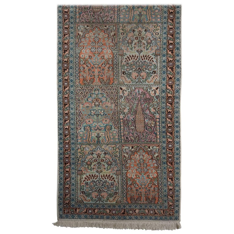 Luxurious Persian pale blue field silk runner with fringing either end. Displaying central pastel colored block panels featuring scrolling Persian arches above blossoming foliage with elegant leaves and flowering stem details encased by floral vine