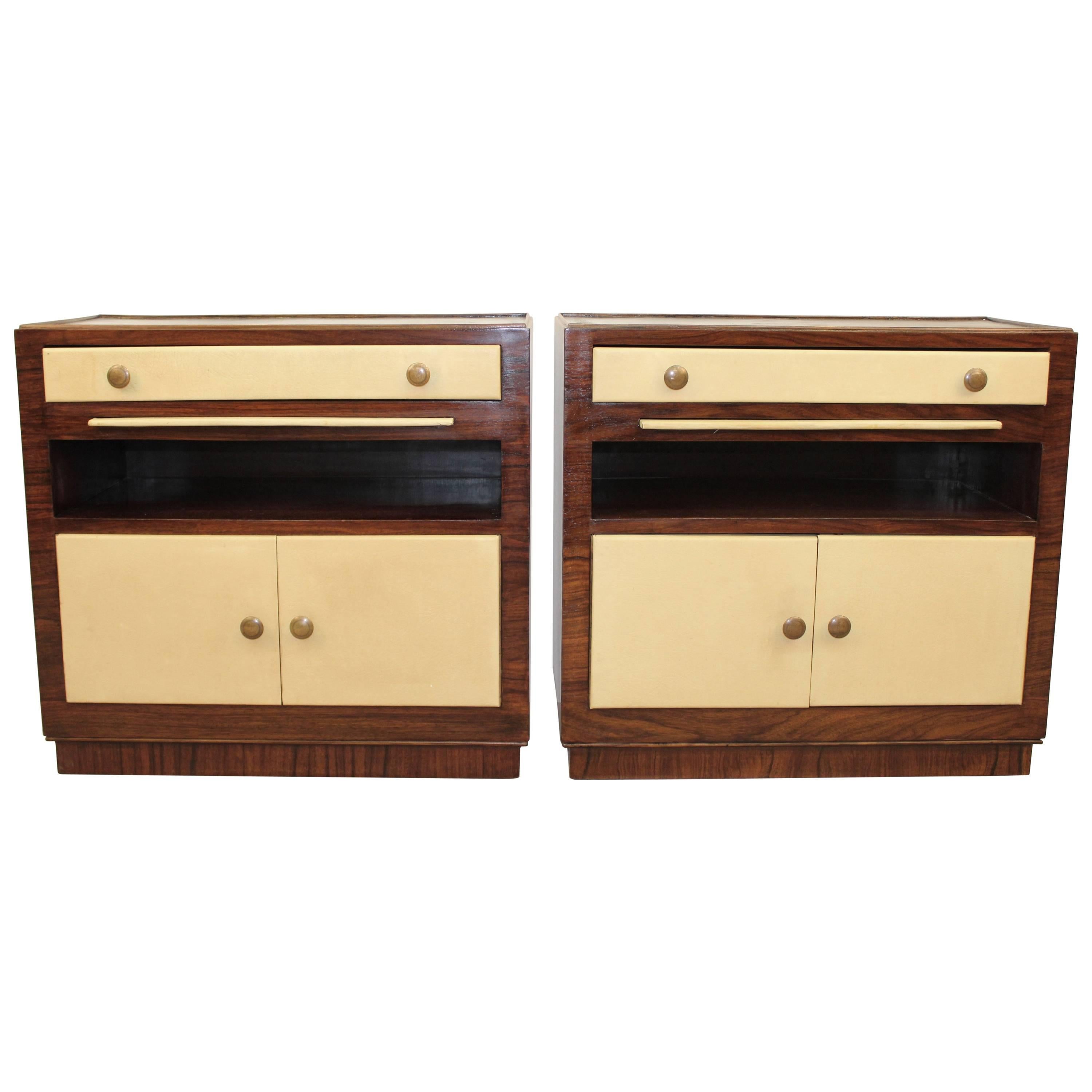 A pair of Art Deco era nightstands, European in origin, each with ivory toned leather front single drawer on two-door cabinets against rosewood frames with brass pulls and marble tops. Excellent vintage condition, with age appropriate wear.

110074