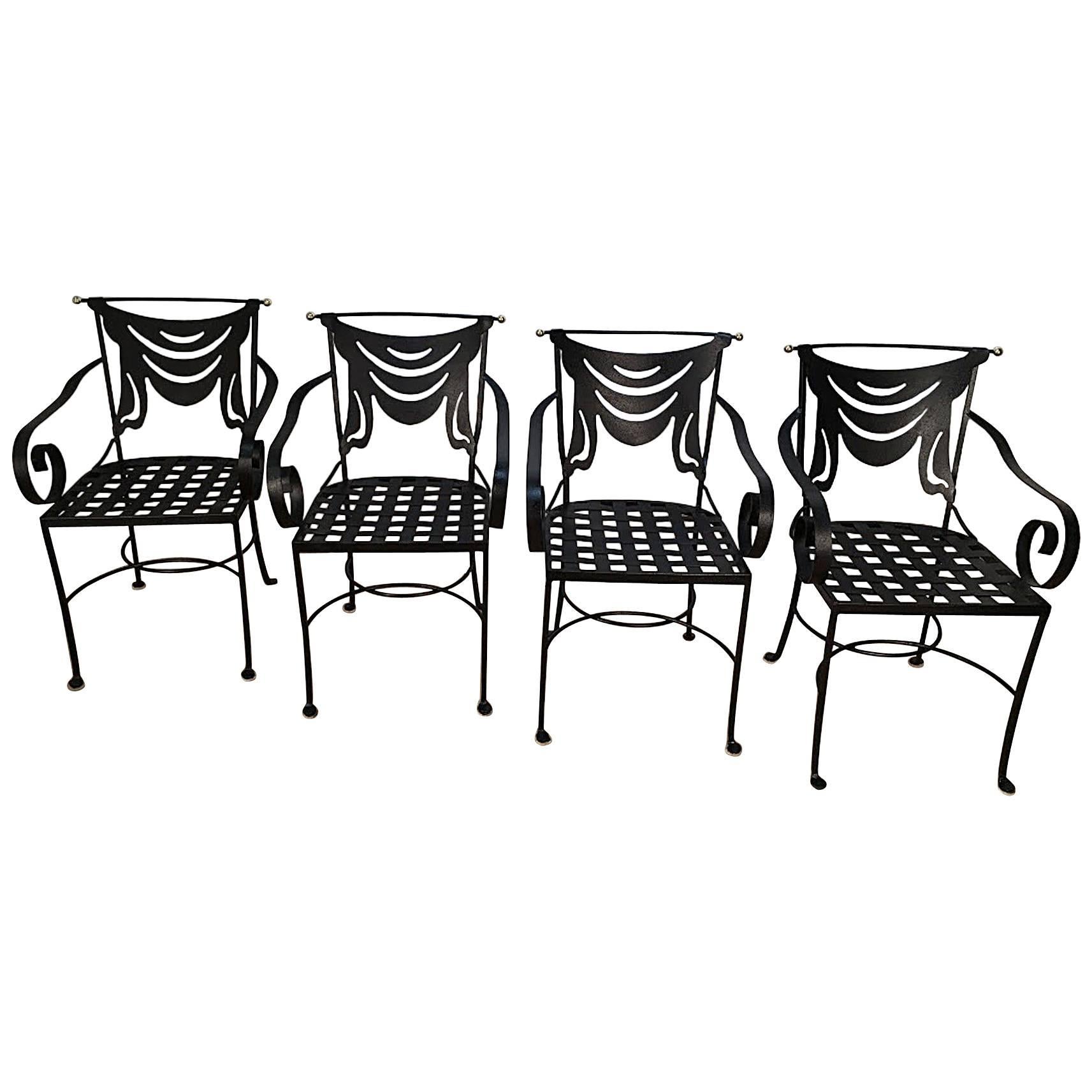 Set of Italian four iron and brass neoclassical armchairs, each one with pierced draped backrest and woven iron seat. Measure: The seat height is 16.5 inches.
