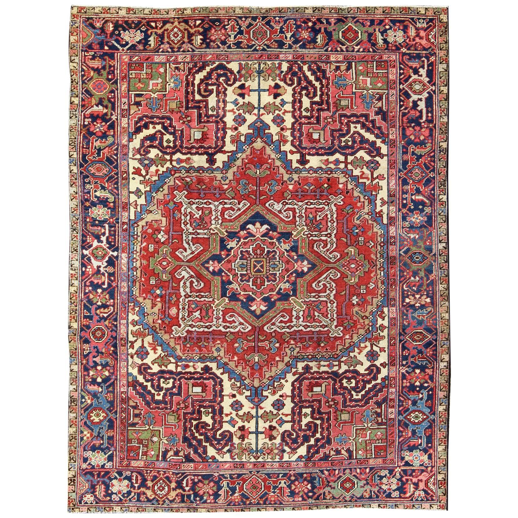 Antique Persian Heriz Carpet with Stylized Central Medallion in Warm Hues of Red