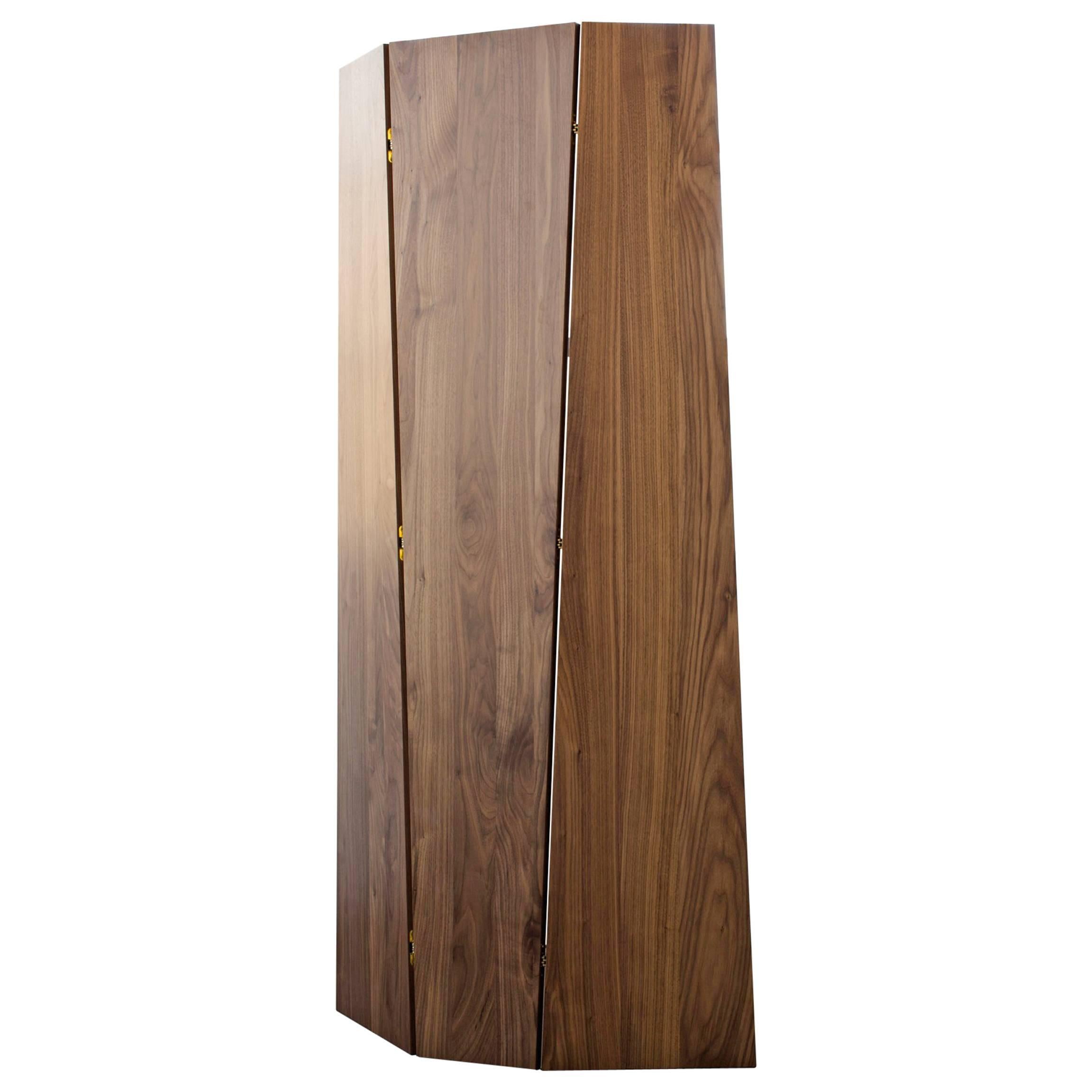 Sculptural, self-supporting screen for use as a stand-alone or combined to create a larger privacy wall. The tri-fold design can be oriented with the form tapering either up or down. 

Shown in solid walnut and bronze.

Dimensions: 78” height x 42”