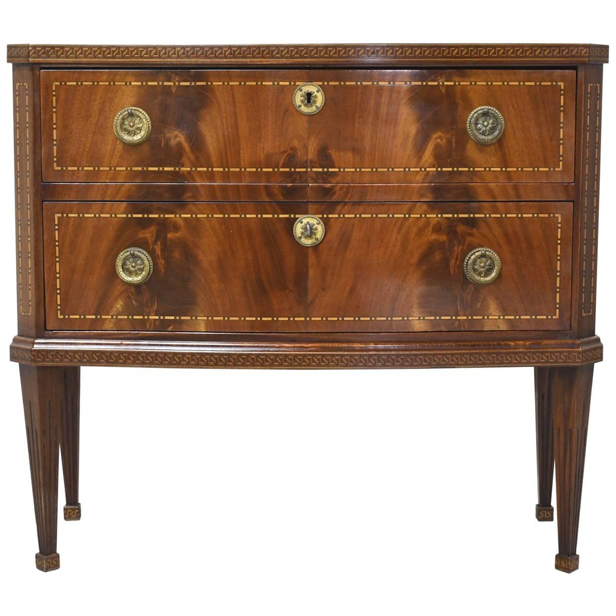 Chest with two drawers on four square tapering legs with book-matched crotch mahogany front with marquetry inlays of Greek key along top and bottom edge and decorative inlaid bandings delineating drawer fronts, chamfered corners and sides. Denmark,