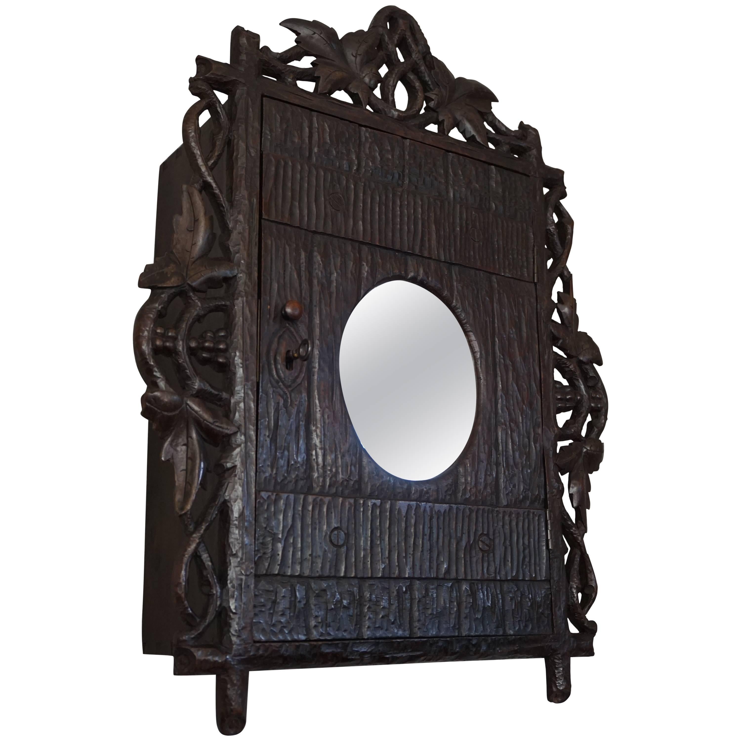 Antique and Hand-Carved Black Forest Medicine Wall Cabinet with Oval Mirror