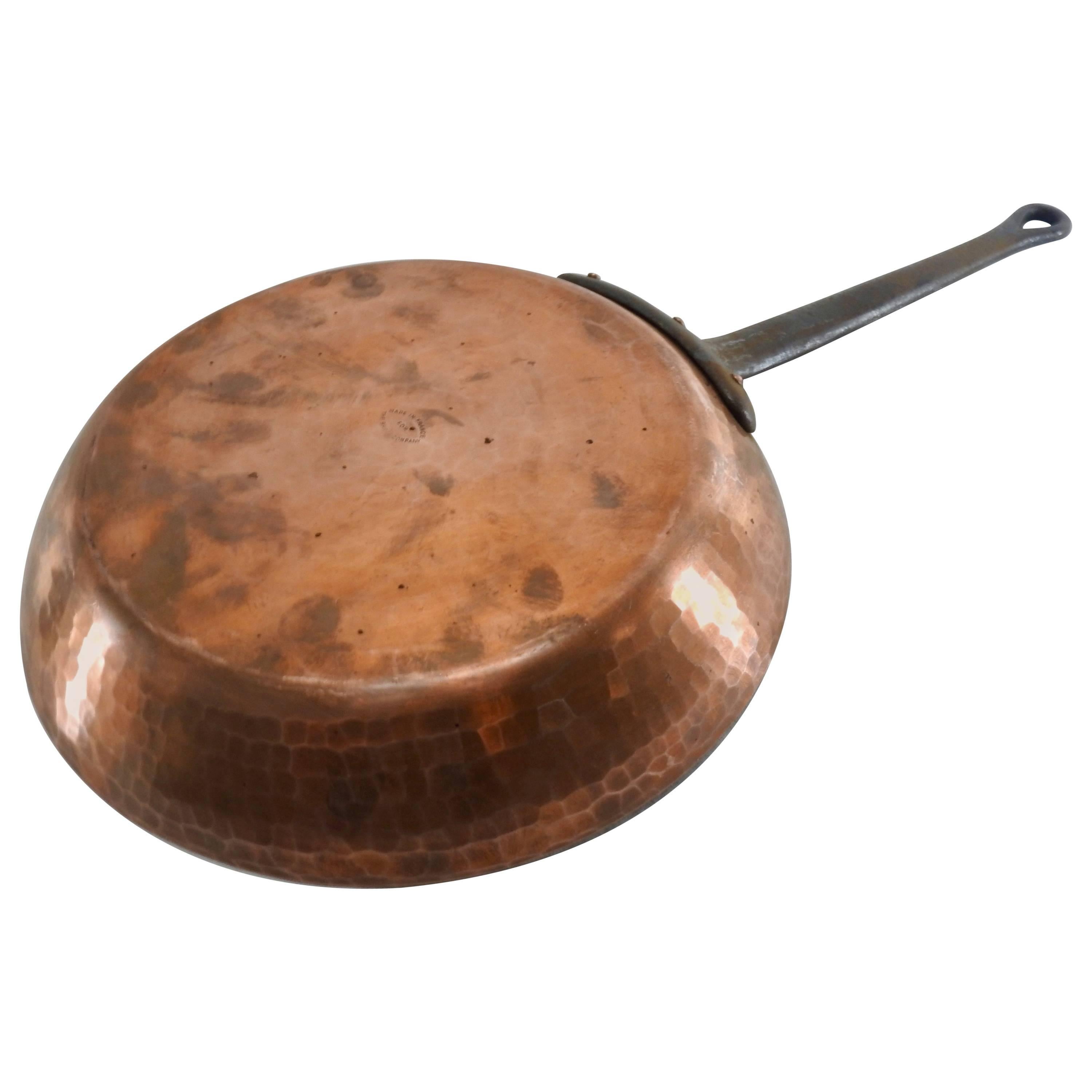 Hammered copper gives this frying pan character. A long cast iron handle is attached. The pan is marked 
