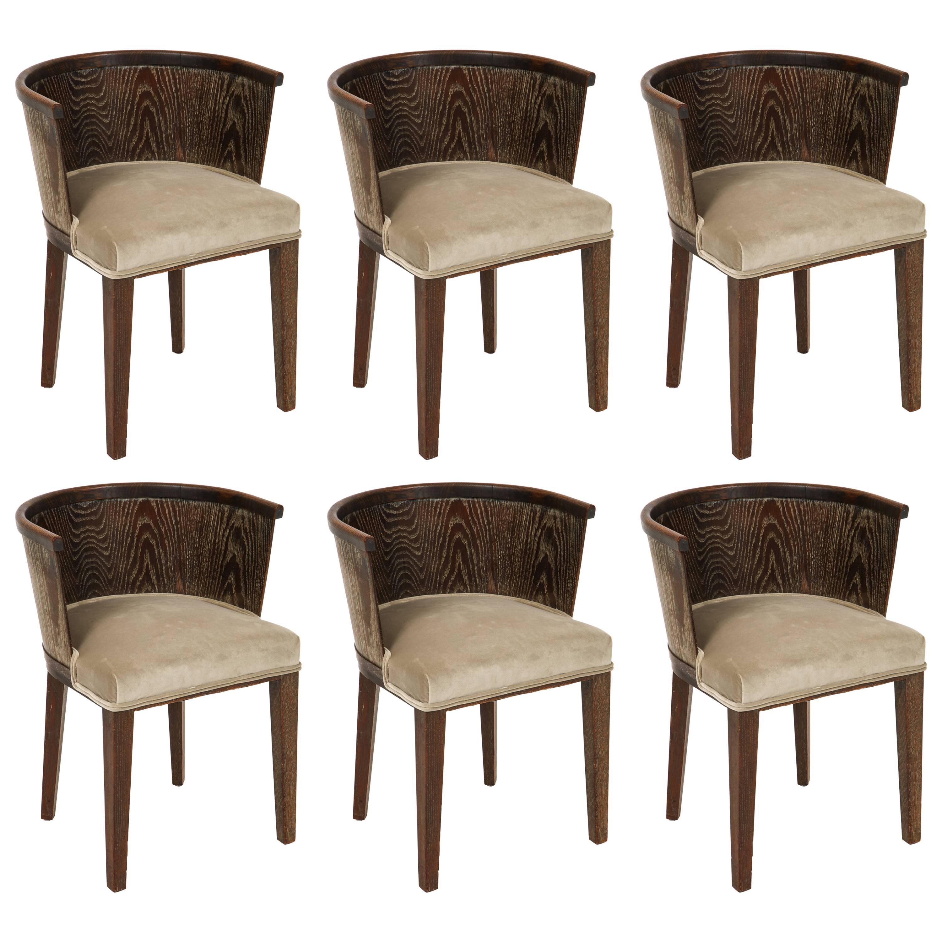 Marjorelle six cerused grey oak barrel chairs Art Deco, France, 1930-1940

Beautiful and rare. Six brown cerused barrel chairs in amazing original condition with new grey upholstery. 
These came as a set with a table and are sold with the table