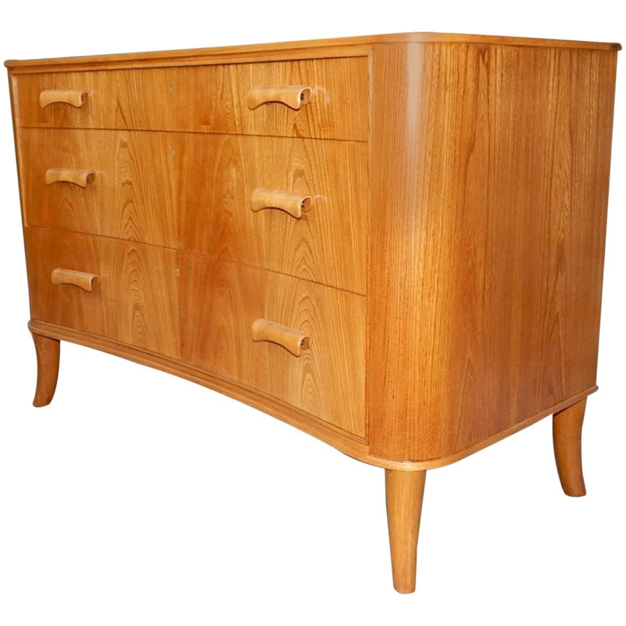 Swedish art moderne era chest of drawers rendered in birch and bookmatched elm. Designed by Axel Larsson for Bodafors, circa 1940. This piece has been beautifully restored by our woodworkers.