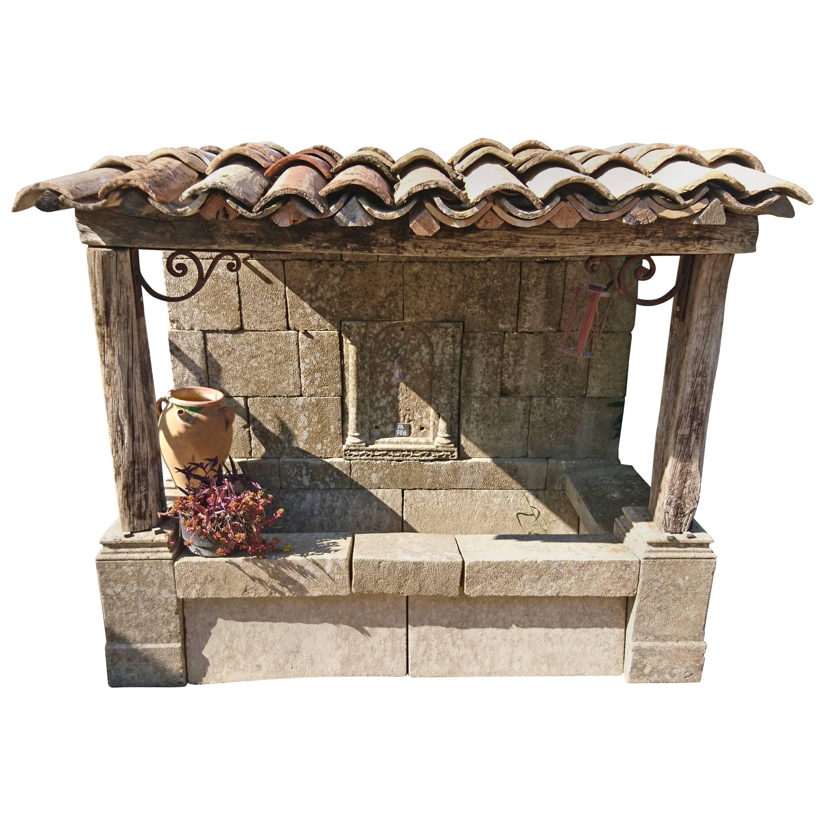 Large Wall-Fountain with Stone Basin, Roof with Wooden Beams and Provence Tiles For Sale