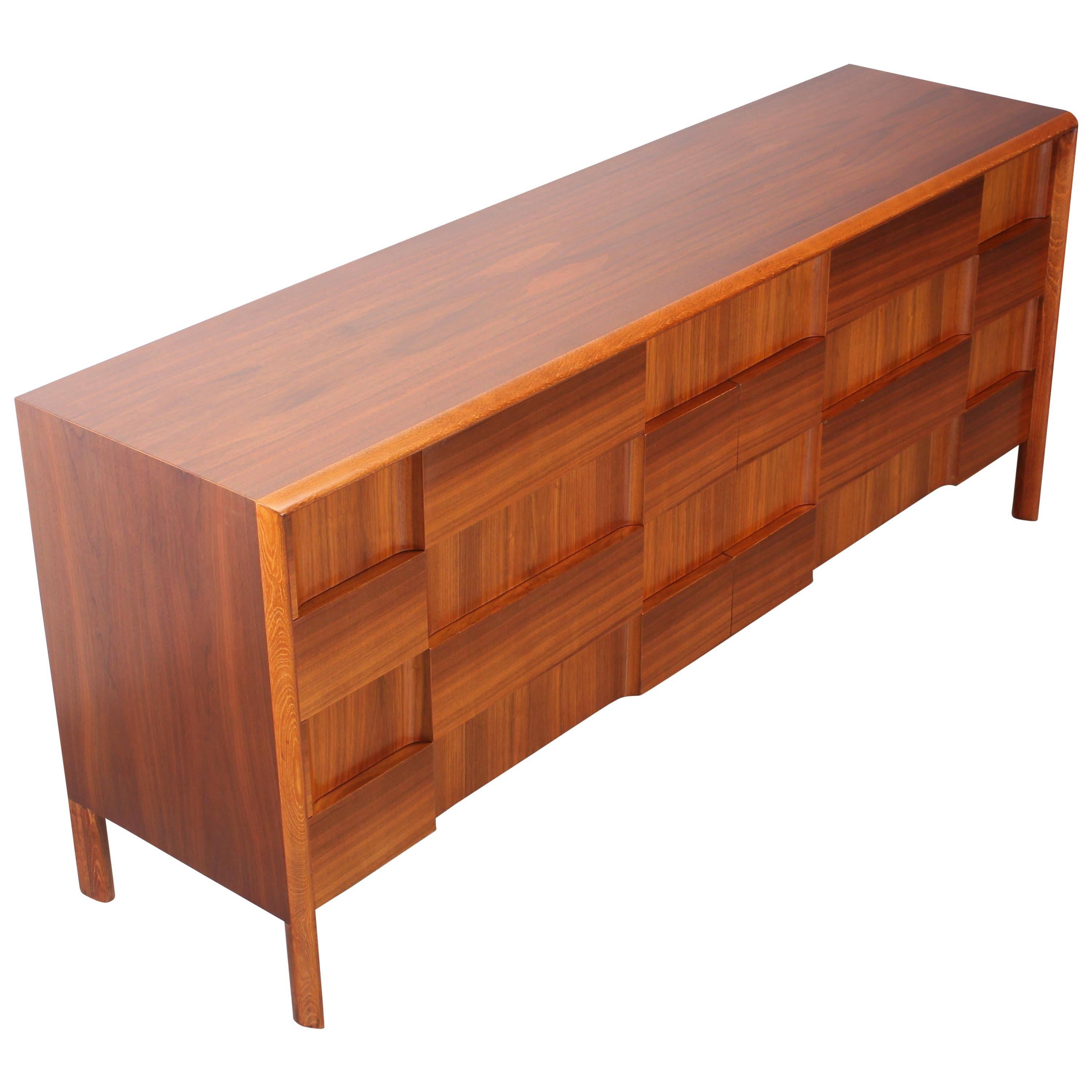 A spectacular 8 drawer relief front walnut dresser made of horizontal and vertical walnut veneer designed by Edmond Spence, made in Sweden. Edmond Spence was an American designer who was influenced by Danish Modernism in the late 1950's. This