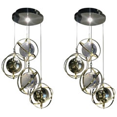 Retro Pair of Brass, Stainless Steel and Lucite Armillary Sphere Chandeliers