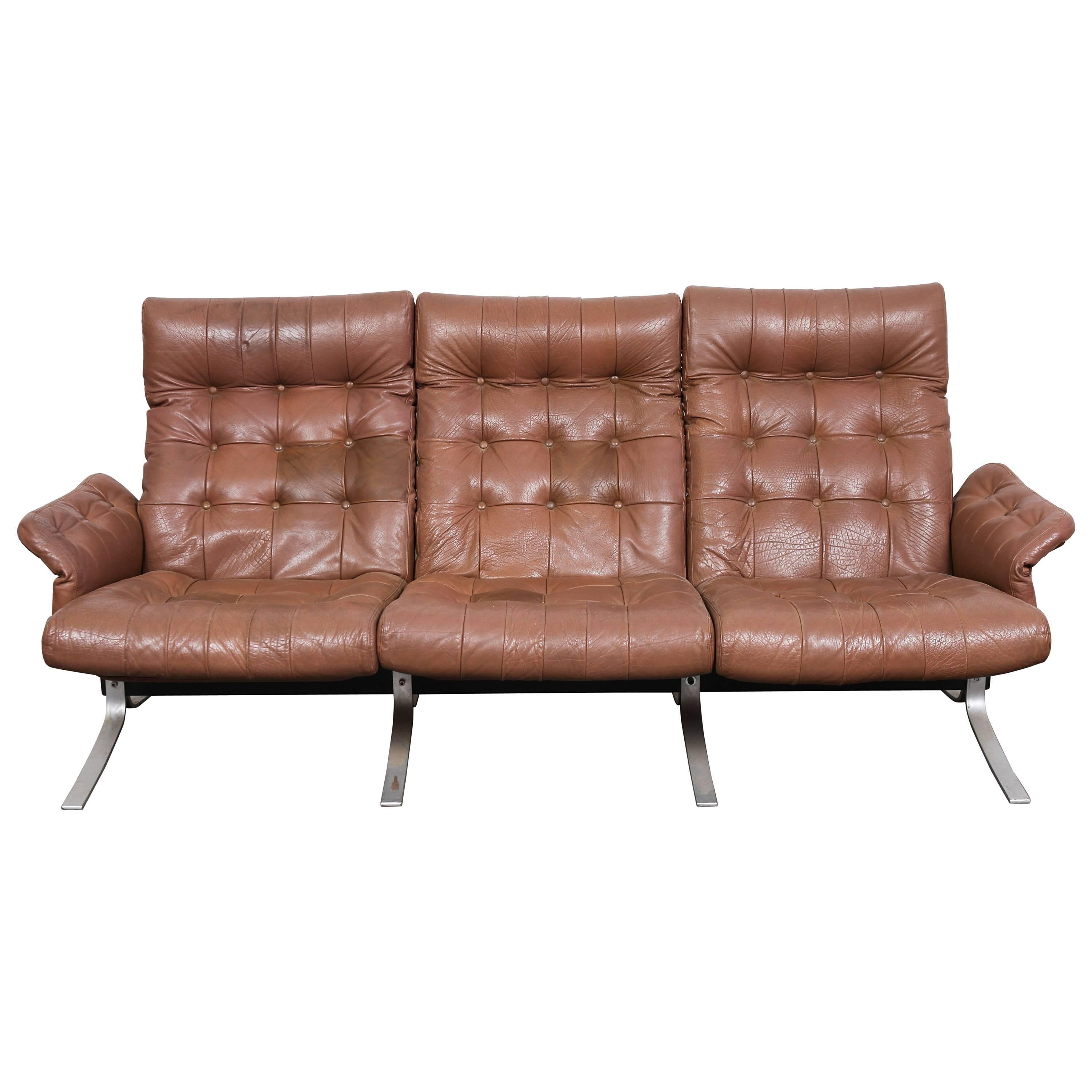 Danish Mid-Century Modern three-seat tufted leather and metal framed sofa by Ebbe Gehl & Søren Nissen. Model 