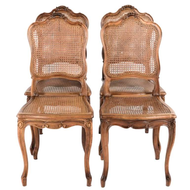 Four French Louis XV Style Cane Walnut Dining Chairs. 