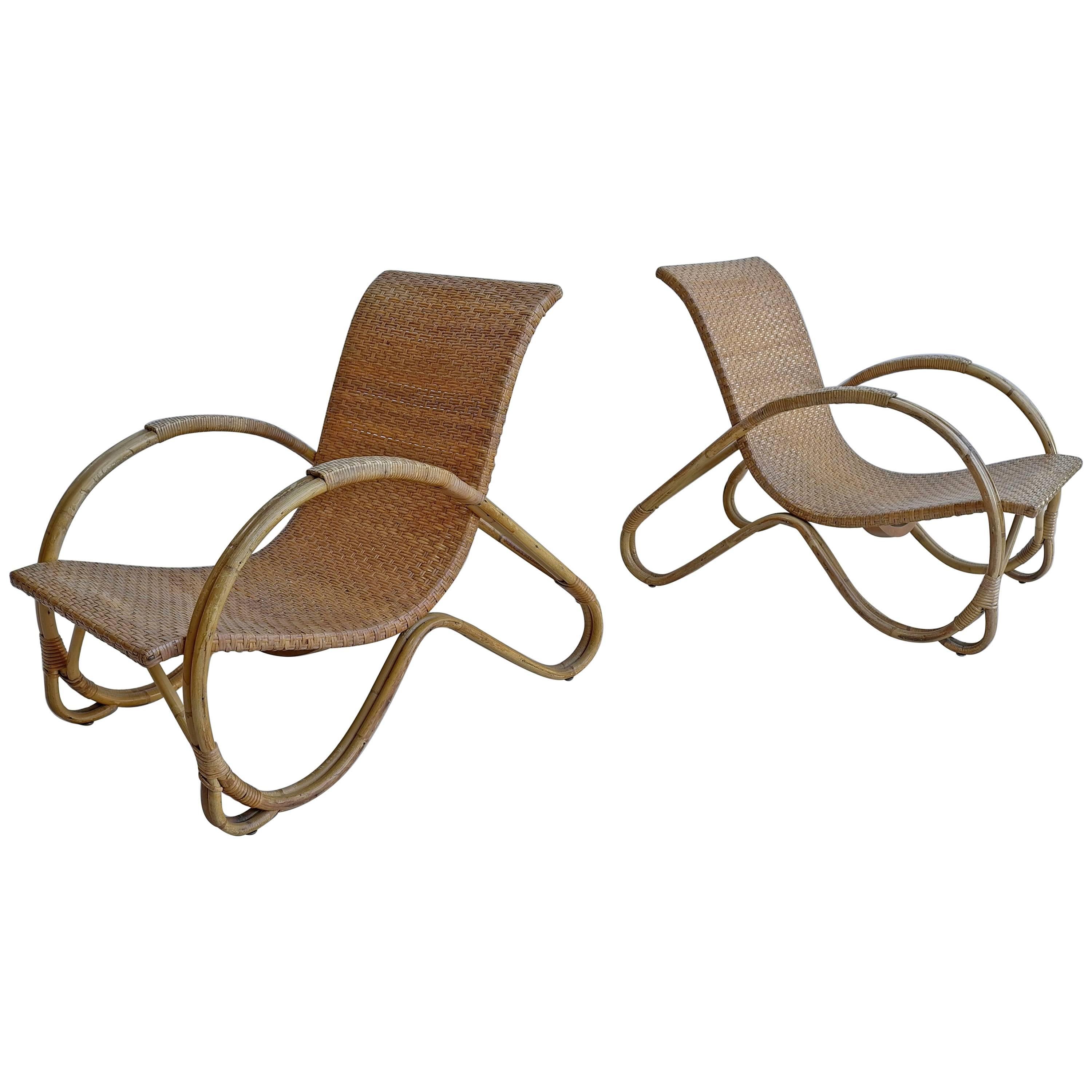 Pair of Mid-Century monumental woven armchairs in rattan.