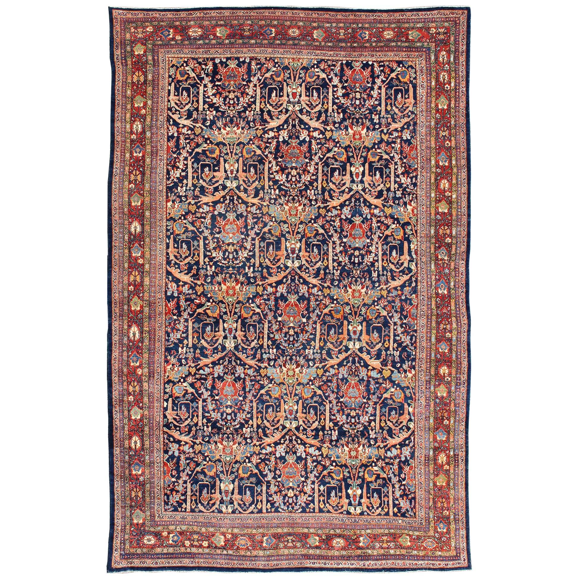 Grand tapis persan ancien de Sultanabad à fond bleu et multicolore