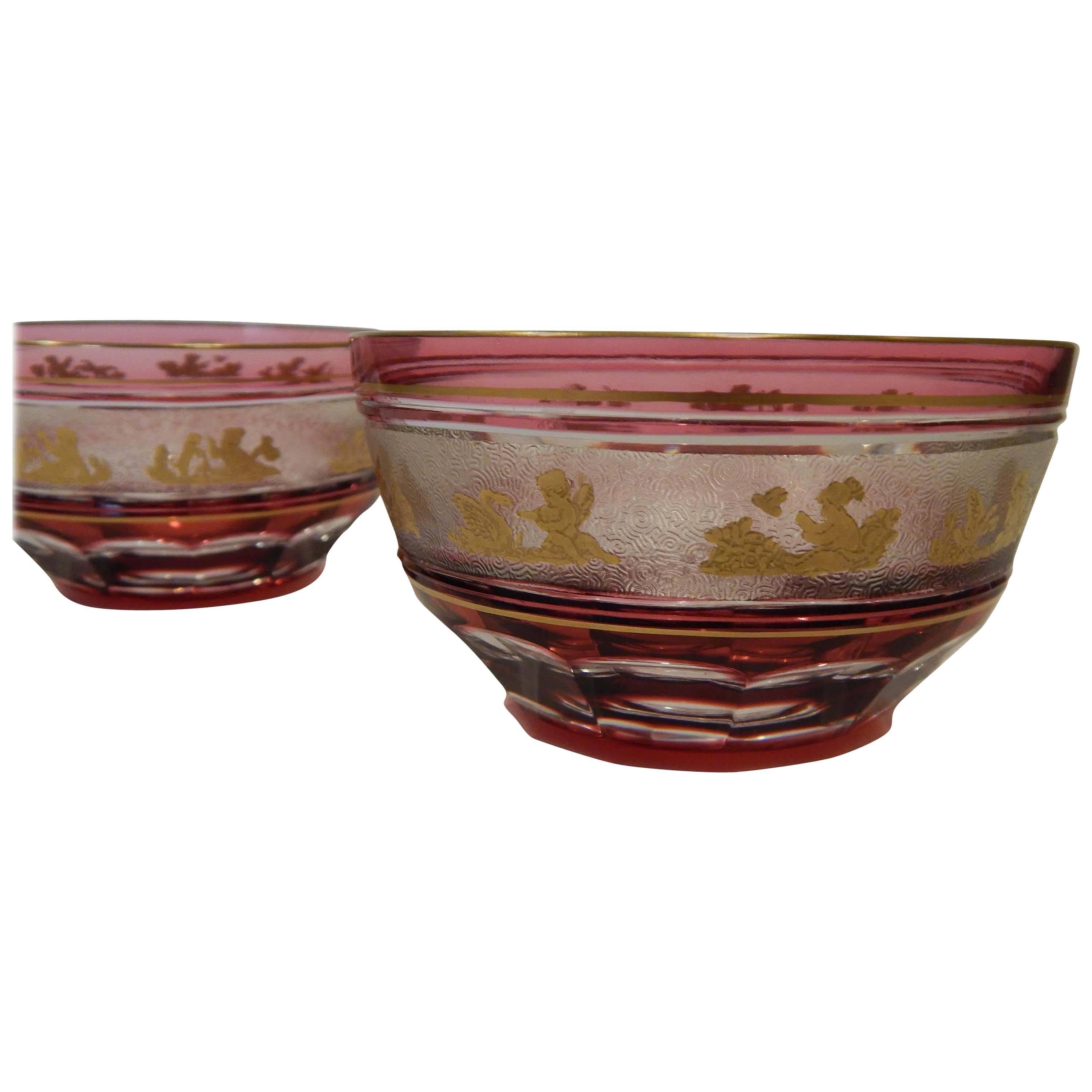 Pair of beautiful Val Saint Lambert hand blown crystal dessert bowls are
overlaid in cranberry and cut to clear. 
Cameo cut with delightful putti (cherubs), flora and fauna, gilded.
These period bowls have etched signatures.
Measures: 2 ½” H x 4