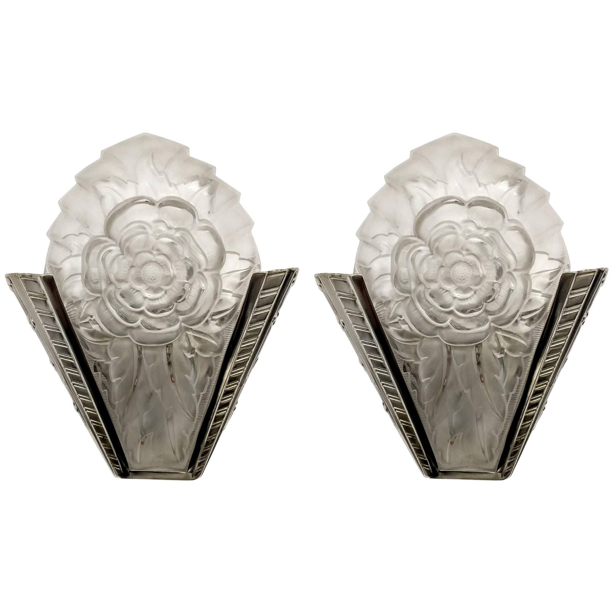A pair of French Art Deco wall sconces are signed by the French artist 