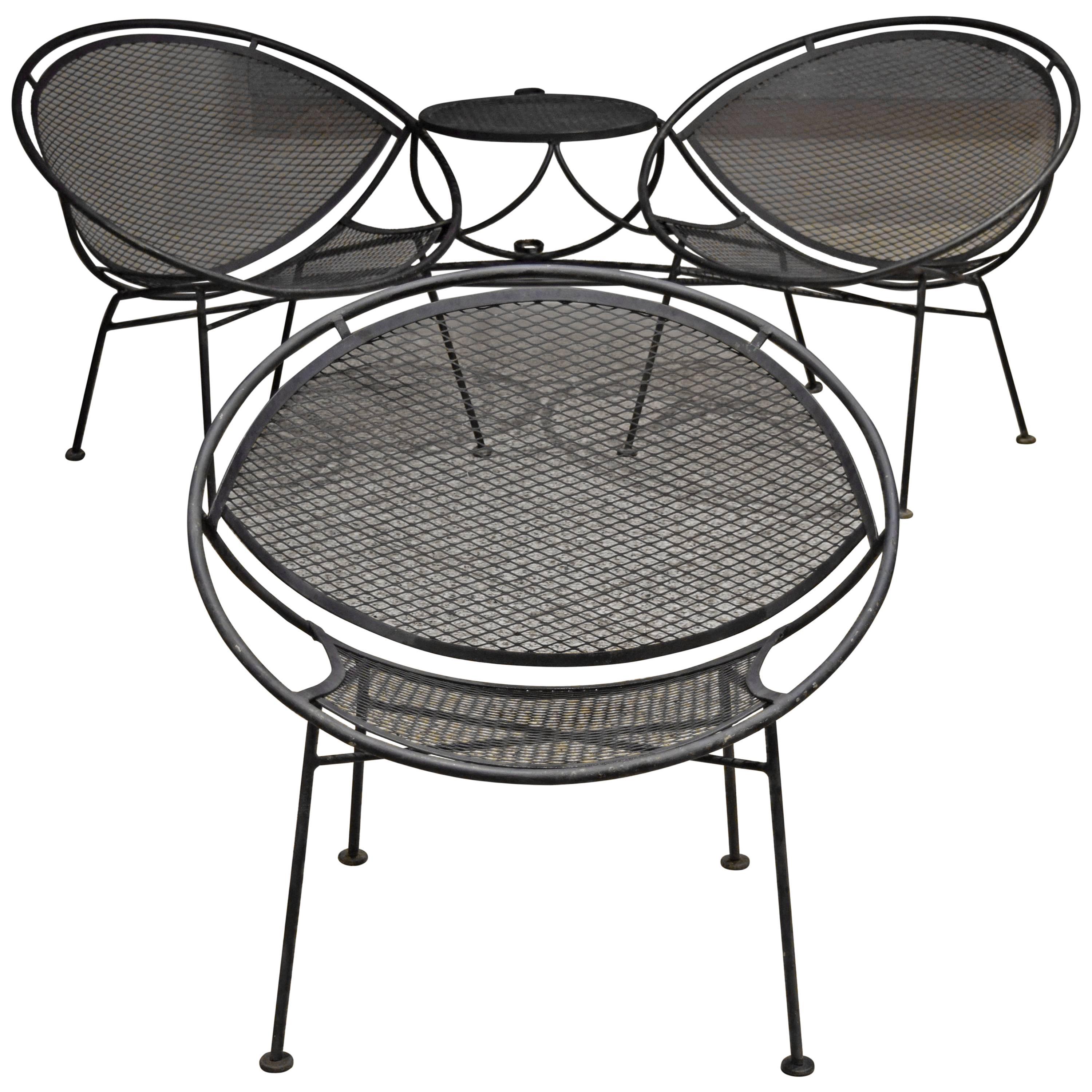 Wrought iron patio set by Maurizio Tempestini for Salterini. Includes tête-à-tête and single lounge chair.