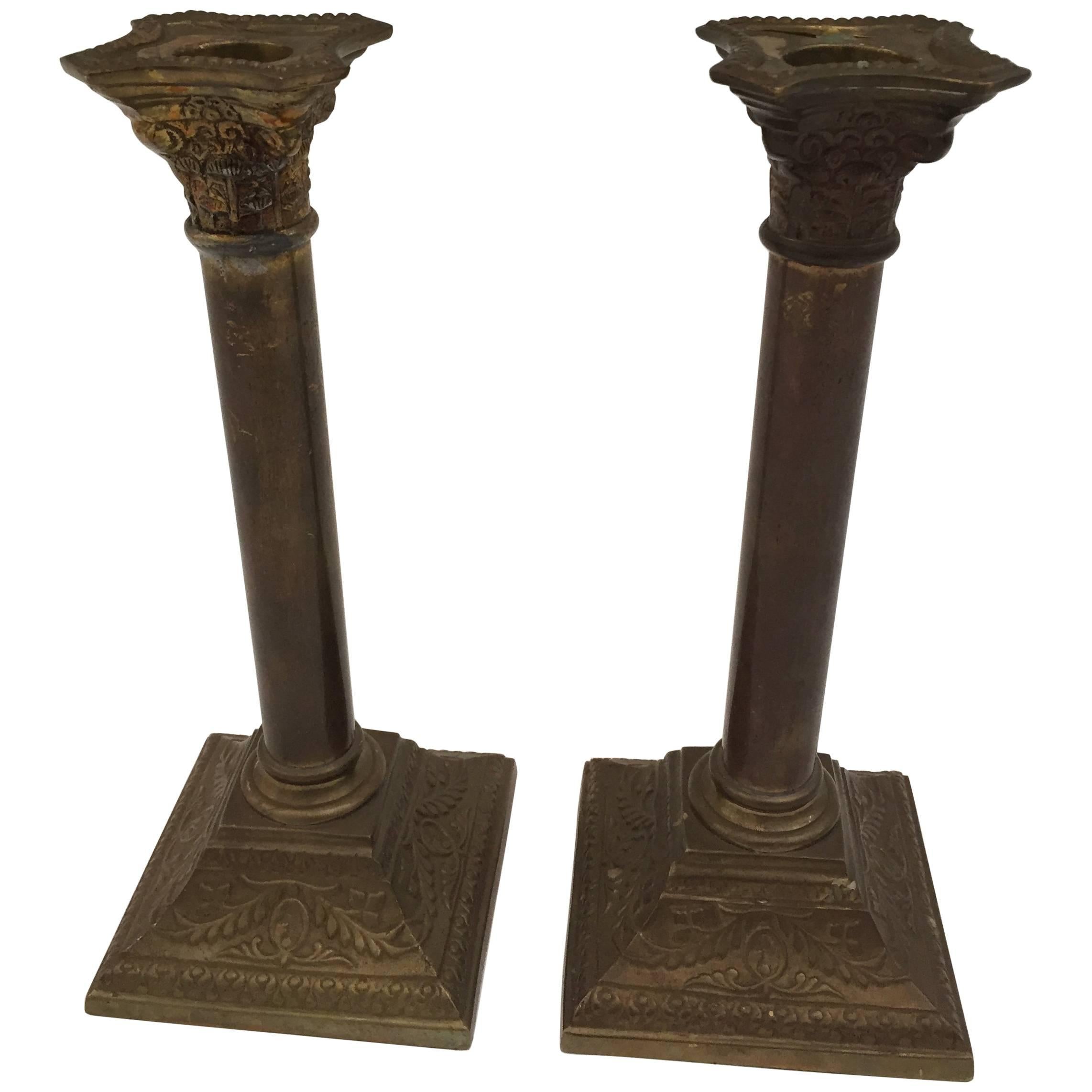 A very nice pair of George III neoclassical style brass candlesticks with square bases and columnar shafts supporting urn form candle cups.
The candlestick are in form of columns, the bases and top are square with neoclassical ornate designs.
Nice