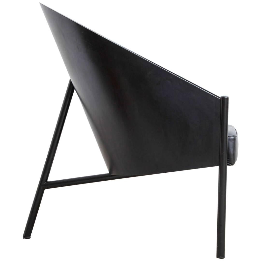 Pair Pratfall easy chair designed by Philippe Starck. Very striking design the chair has only three legs! Featuring black lacquered steel frame with a curved beech lacquered back, upholstered in black leather.