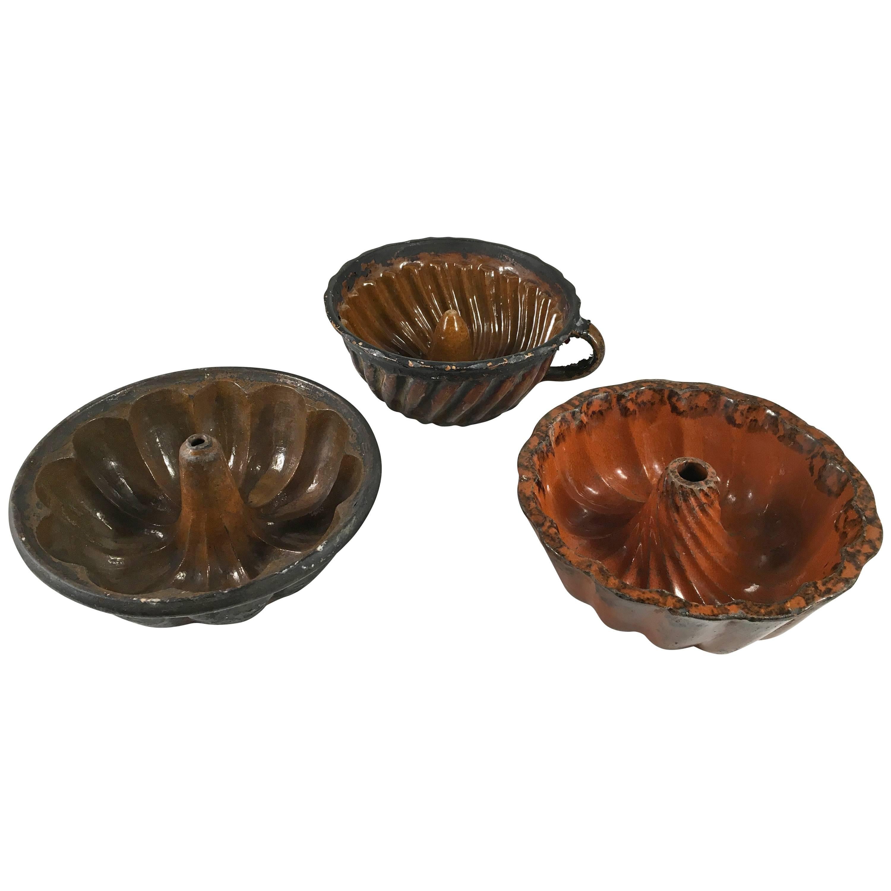 Collection of Three Early Pennsylvania Redware Cake Molds, 19th Century