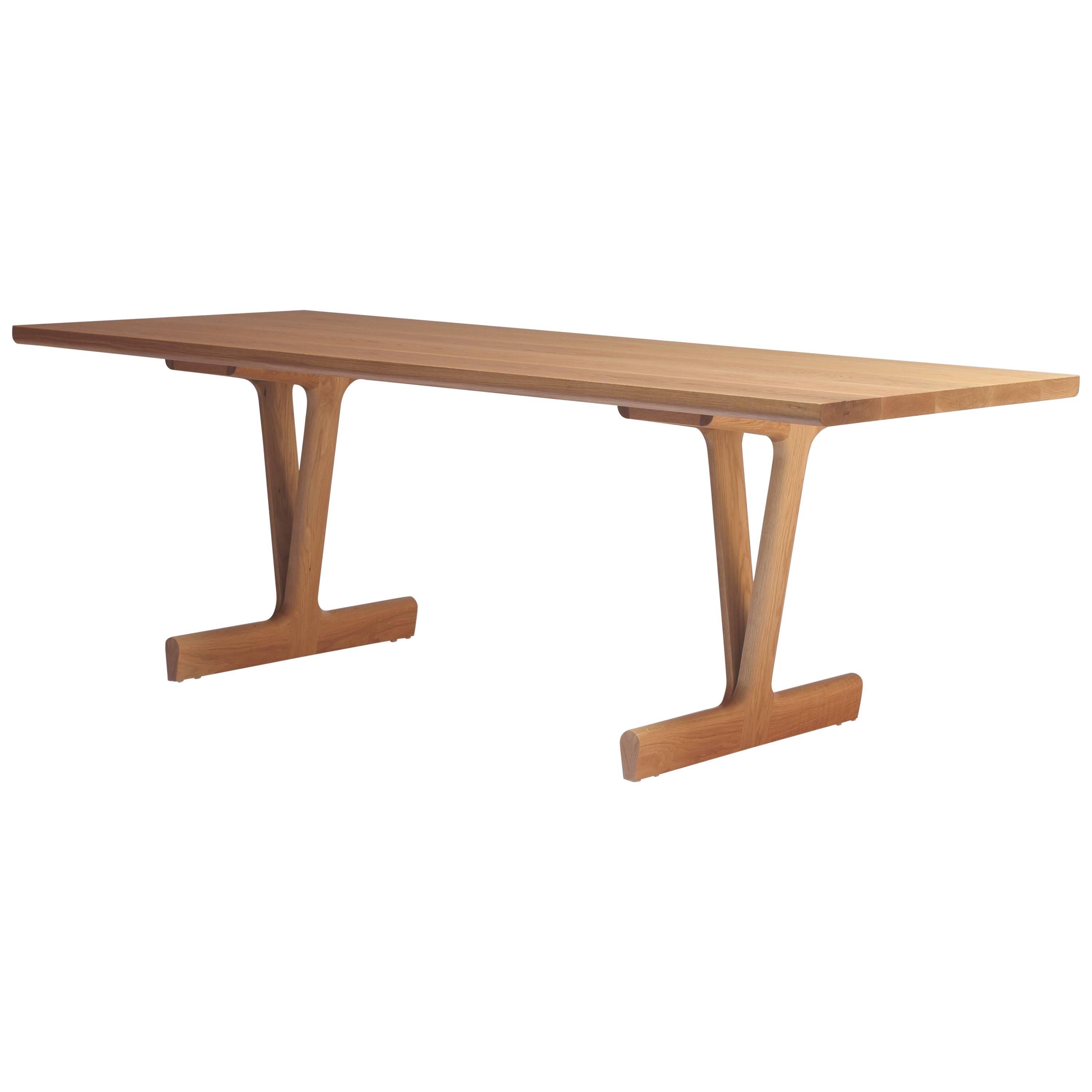 The IV Dining Table was designed by Justin Godar in 2017. The unique leg design provides sturdy support while offering a wide range of seating options. Made in San Francisco from solid white oak and finished in a hardwax oil. 

Sale price is for the