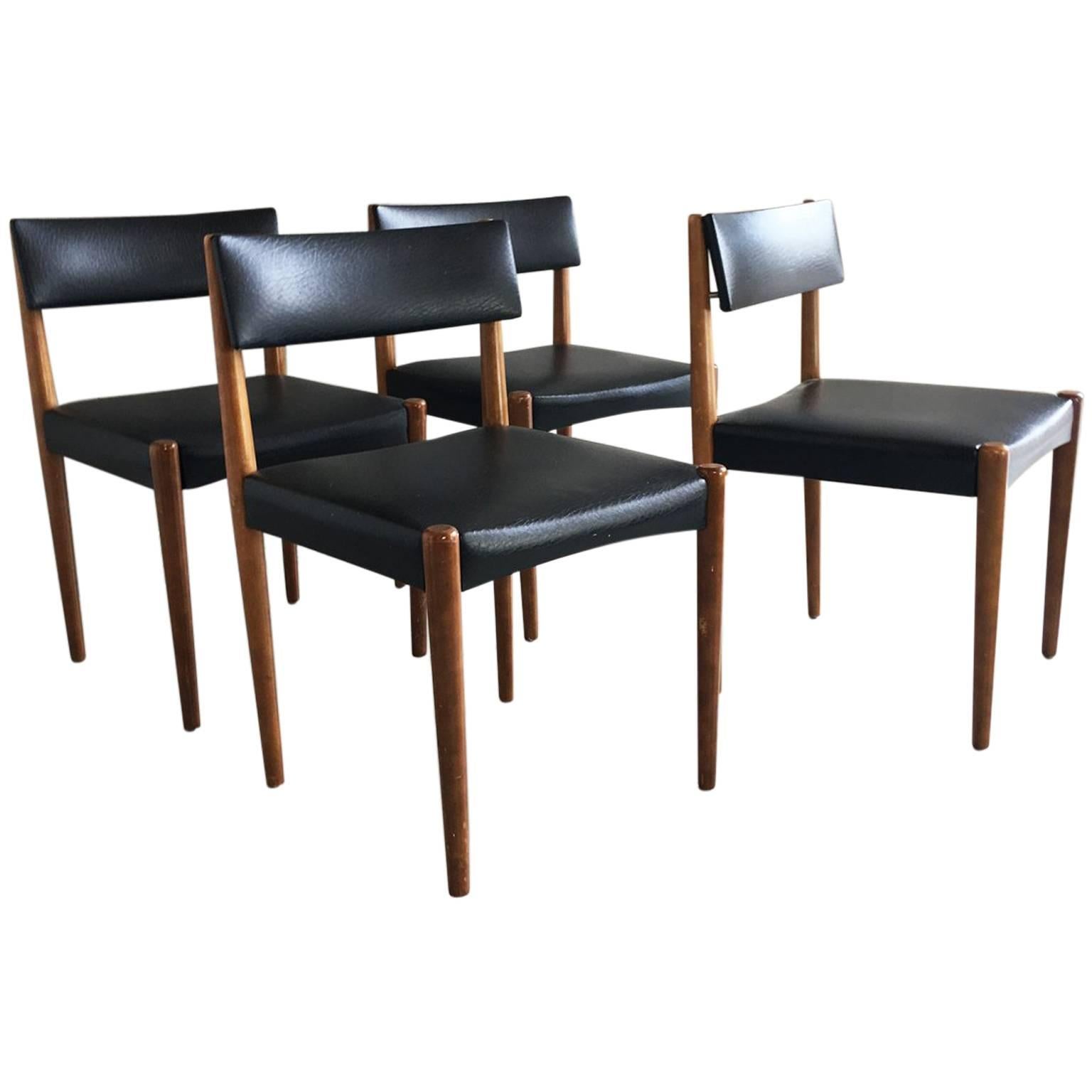 Set of Four 1970s Mid-Century Teak and Black Vinyl Dining Chairs