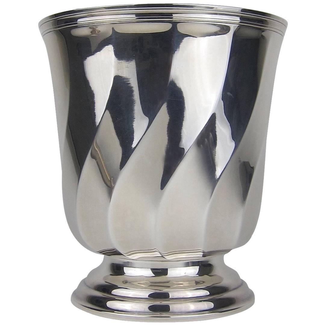 A spectacular French Art Deco magnum-sized champagne cooler from Christofle of Paris. The silver-plated ice bucket features a geometric, wave pattern design resting atop a stepped circular foot

This substantial vintage piece measures 9.25 in. H x