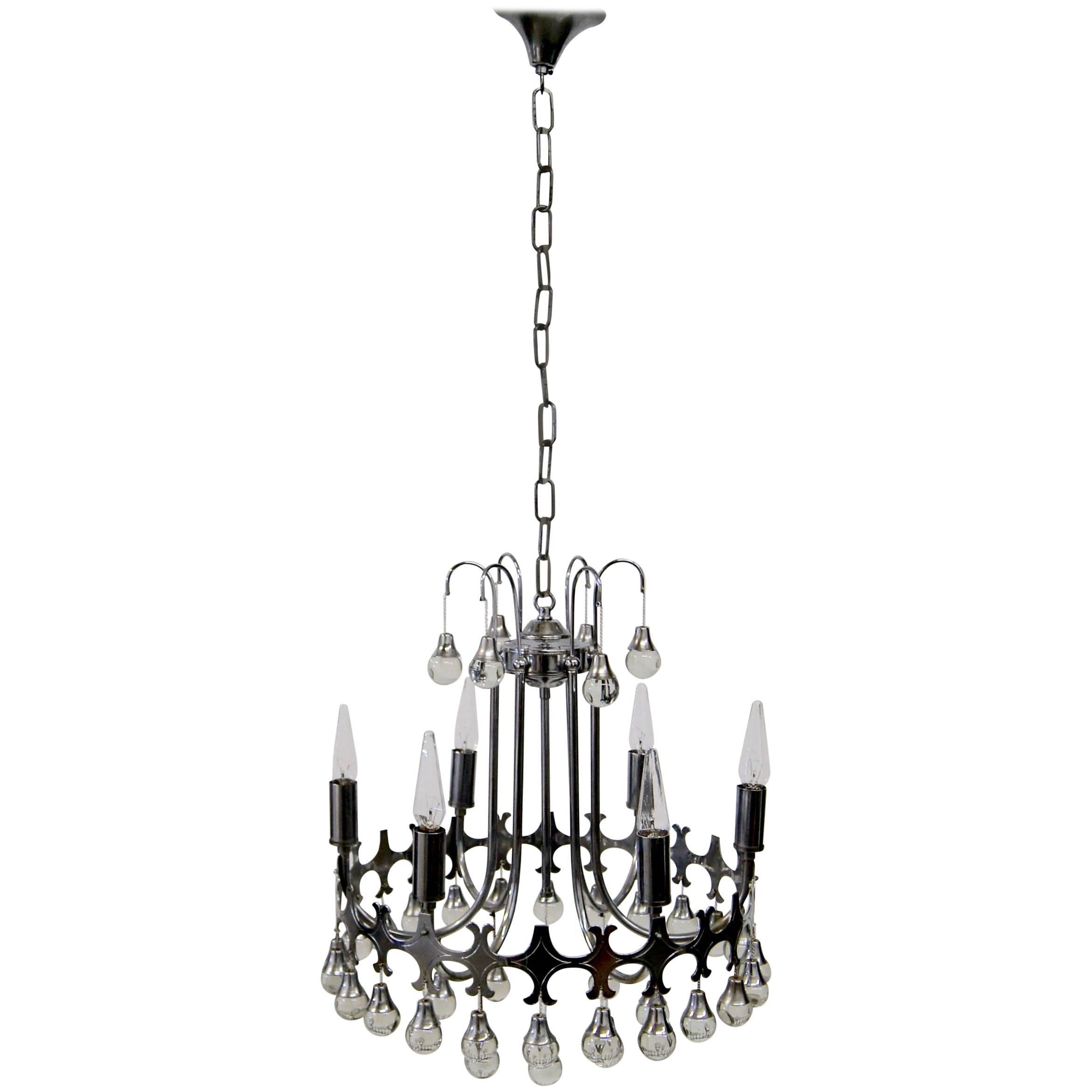 Chrome-plated Italian chandelier with six-light fittings. It is decorated with glass spheres that dangle from small chains attached to the structure.